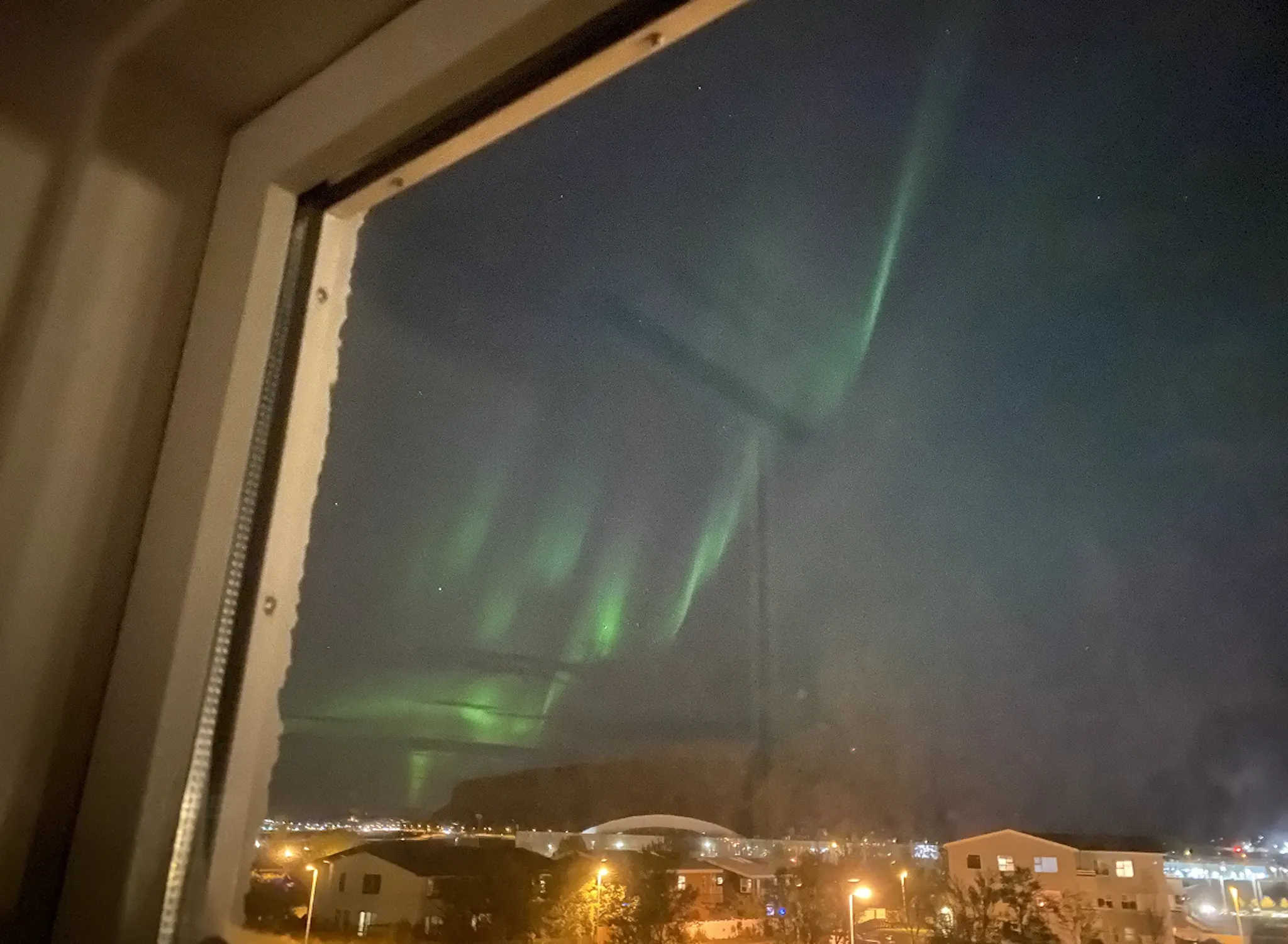 Aurora Borealis dancing in the sky. Watching from the window room. 