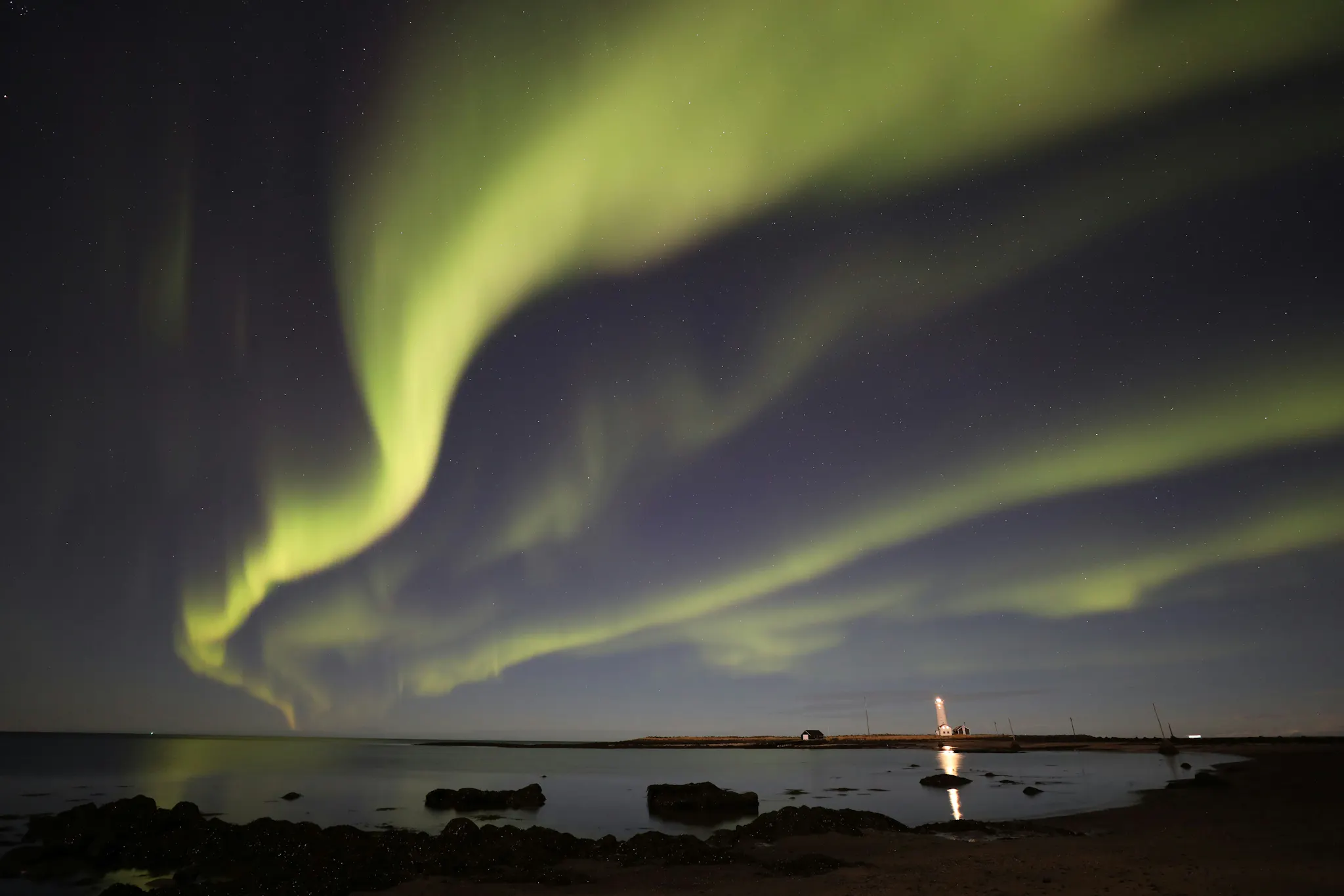 Northern Lights in Grótta Lighthouse in Reykjavík. Iceland. Photo by Toby Elliott from Unsplash.