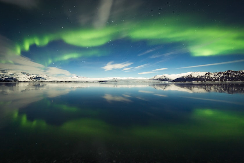 Aurora shaped arc over a lake in Iceland.