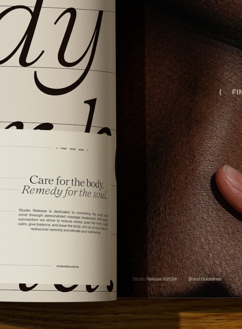 open magazine with left page showing large serif text and right image of hand on skin