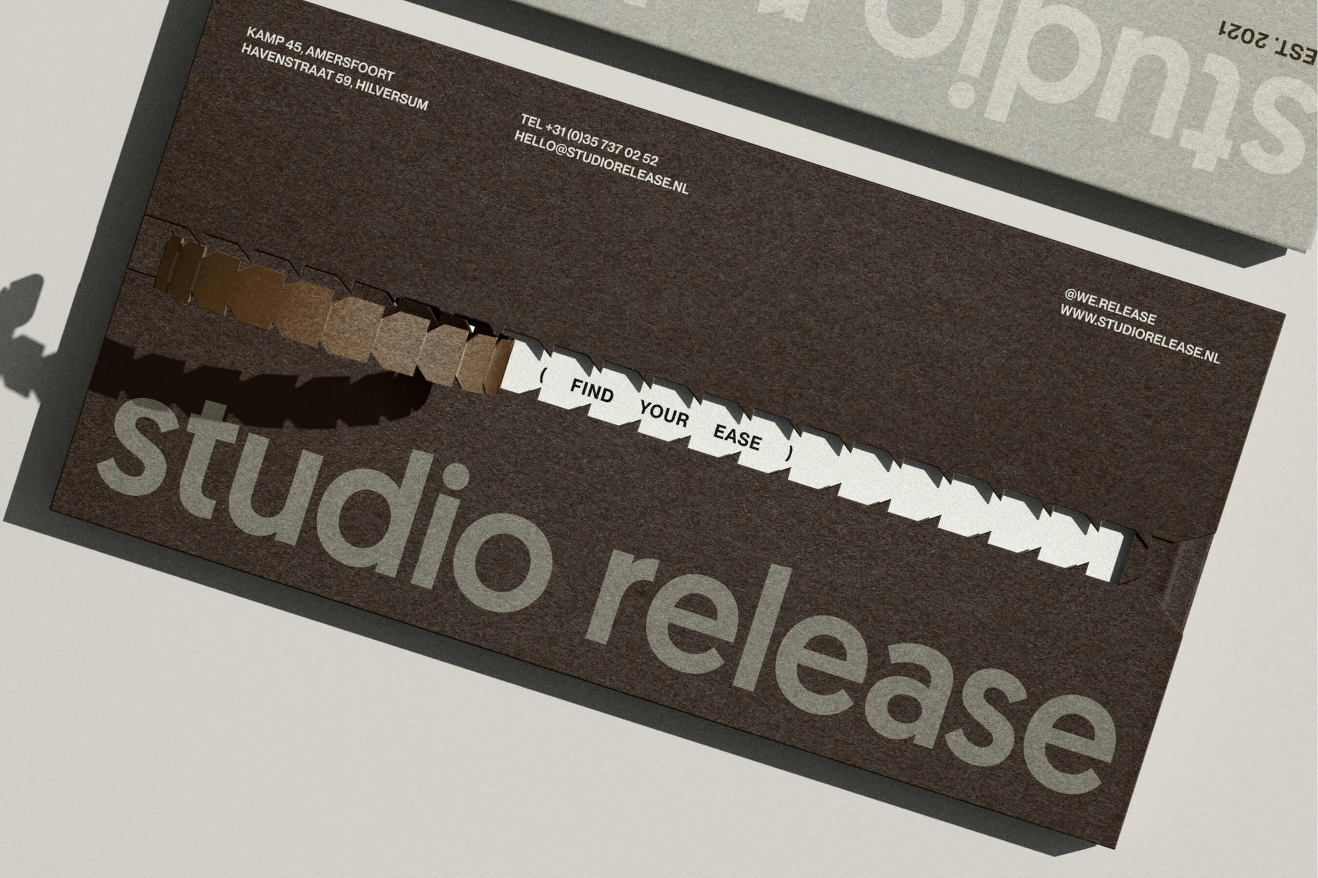 brown envelop being opened with STUDIO RELEASE written on it