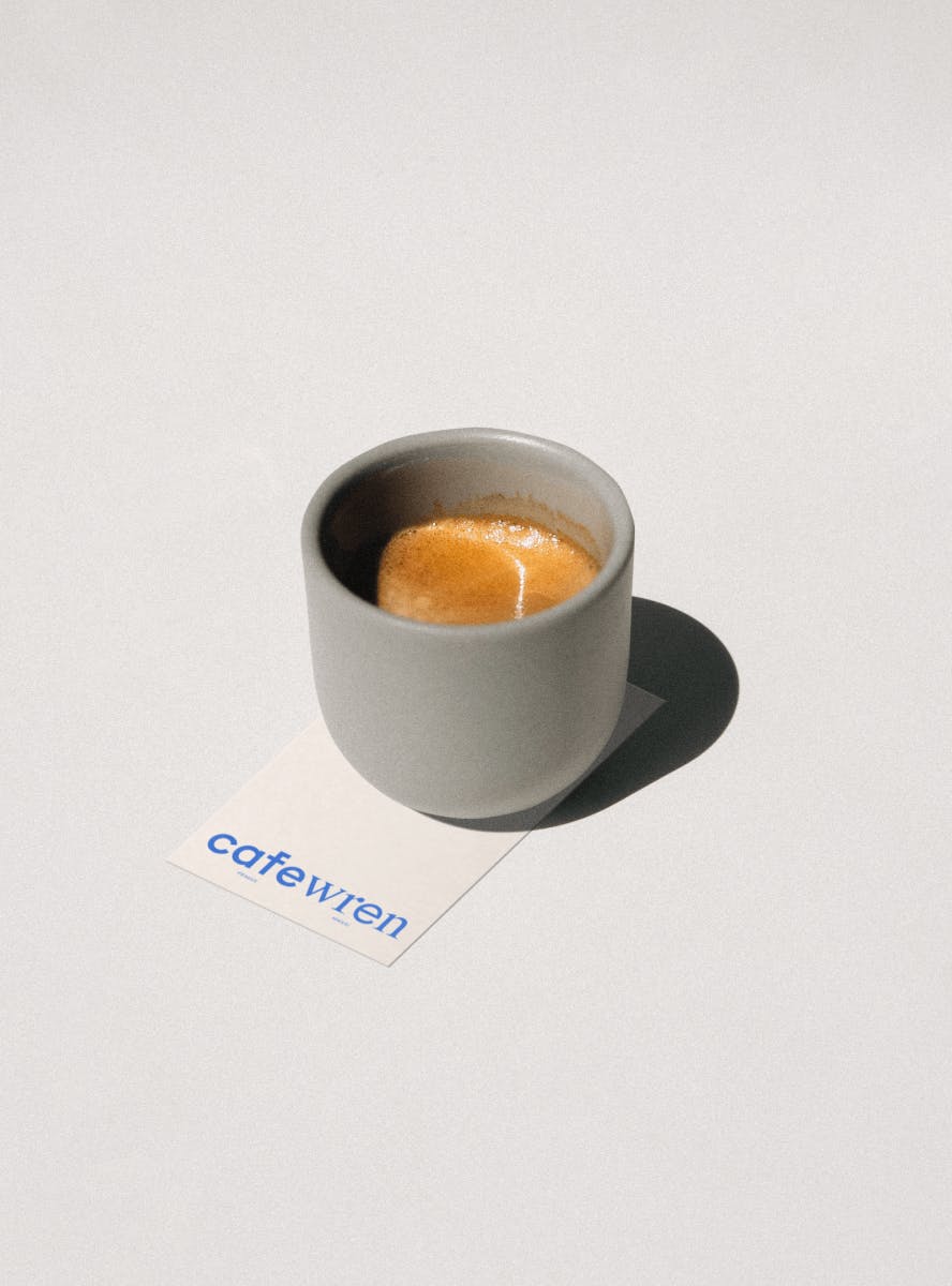 shot of espresso on top of business card