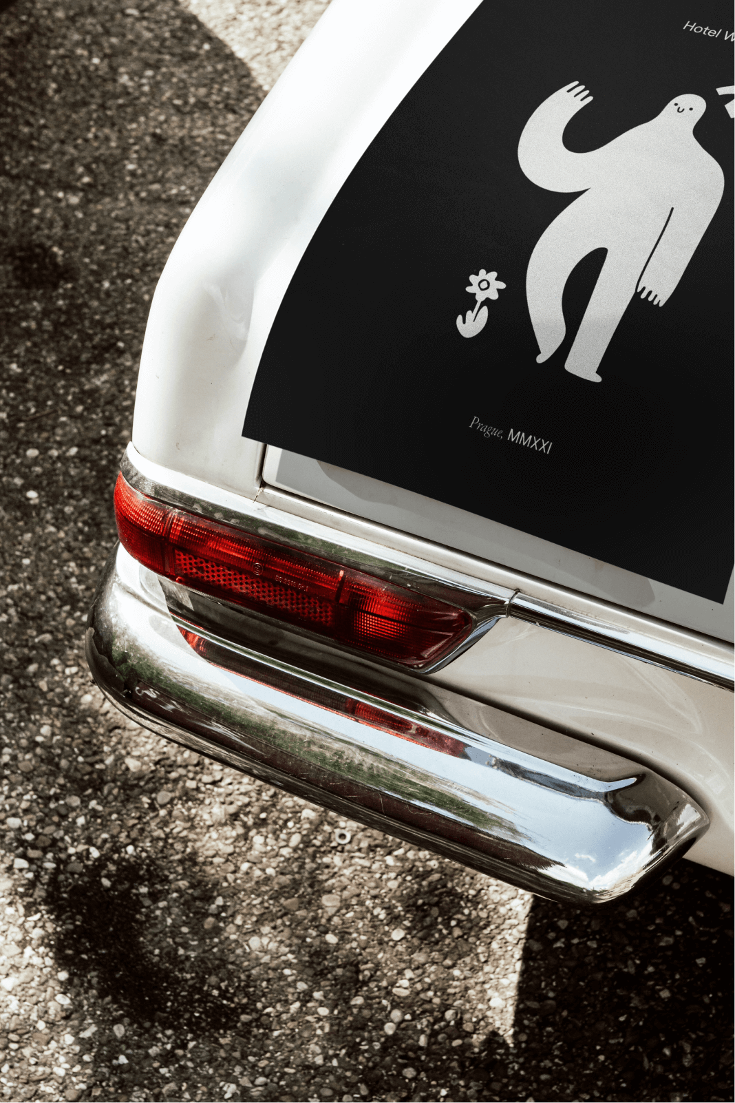 rear of vintage car with poster on top