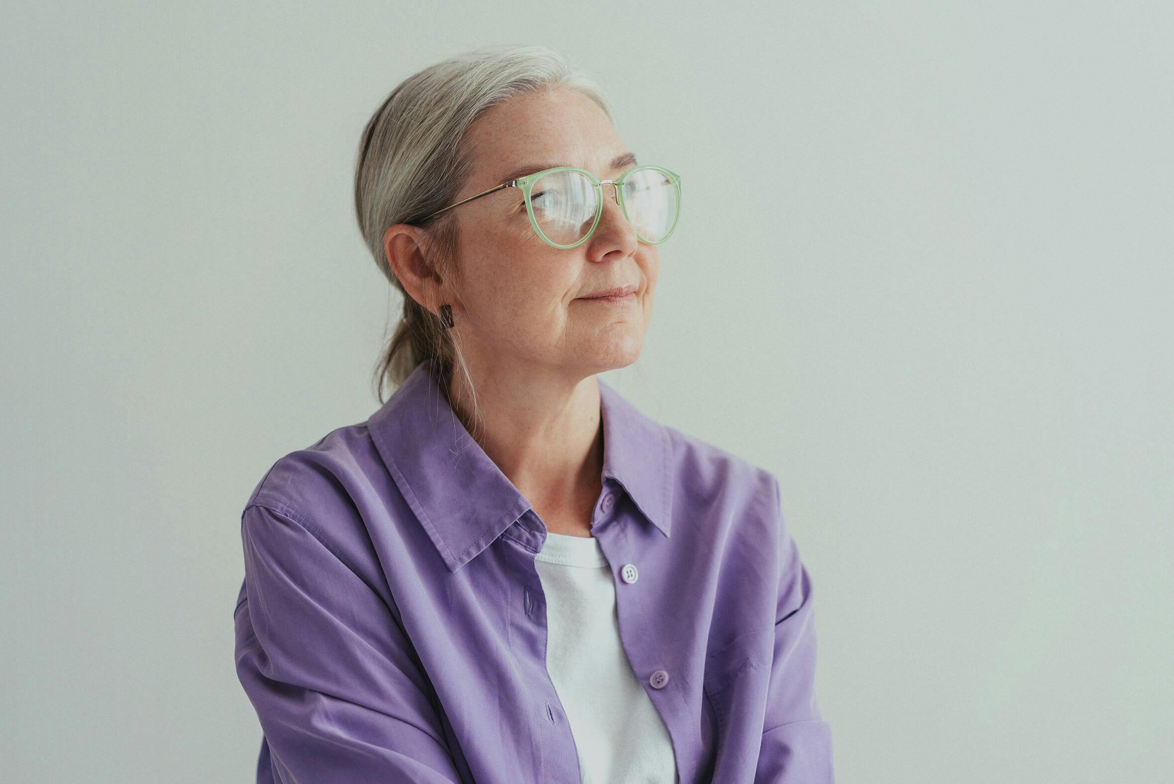 portrait of woman wearing glasses looking into the distance