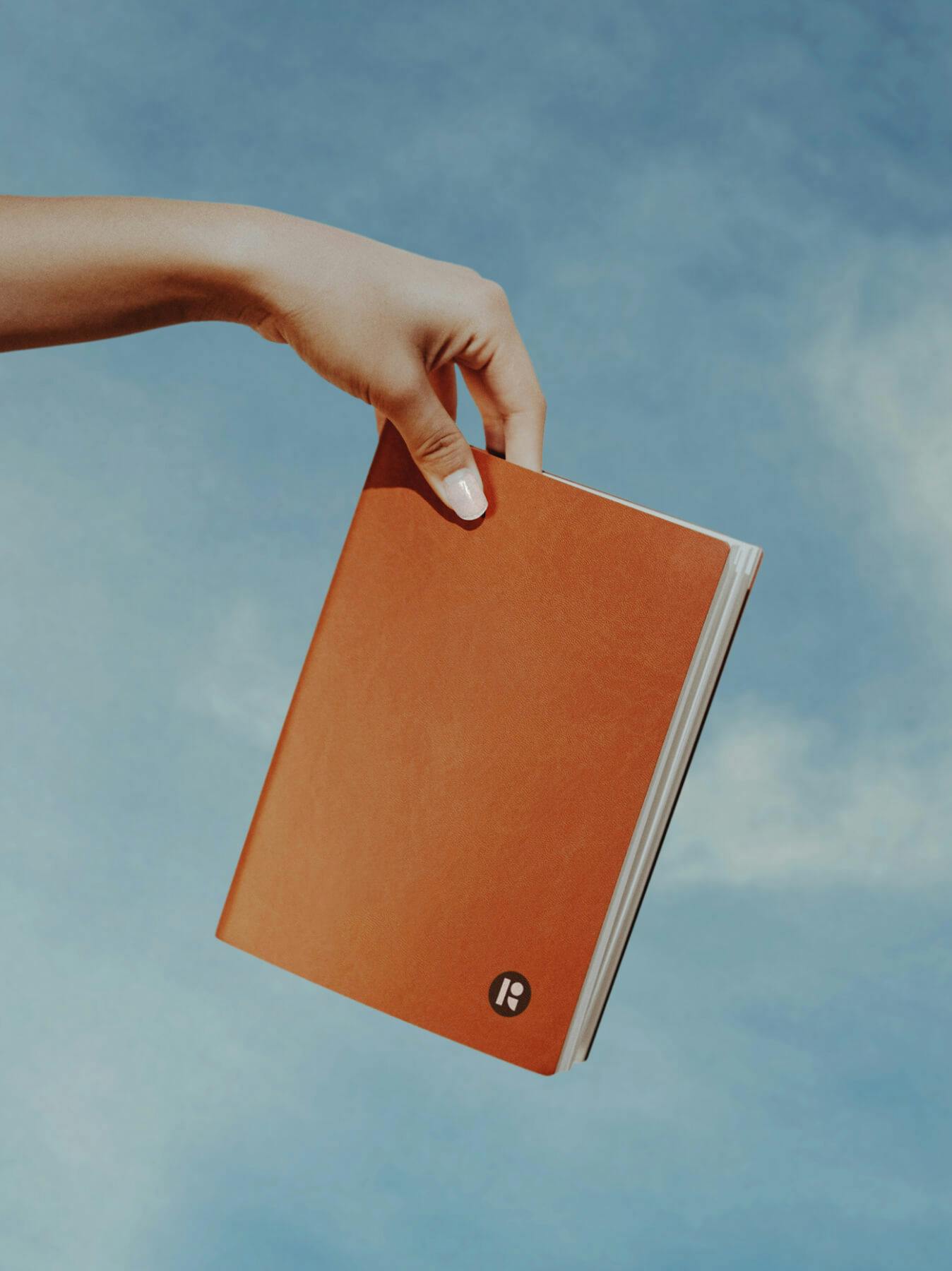 woman's hand holding journal