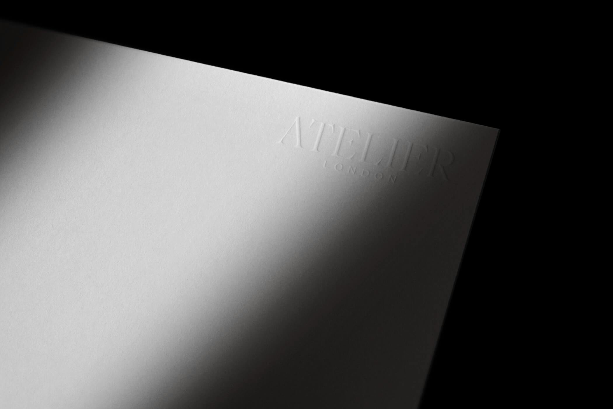 White paper with embossed Atelier logo