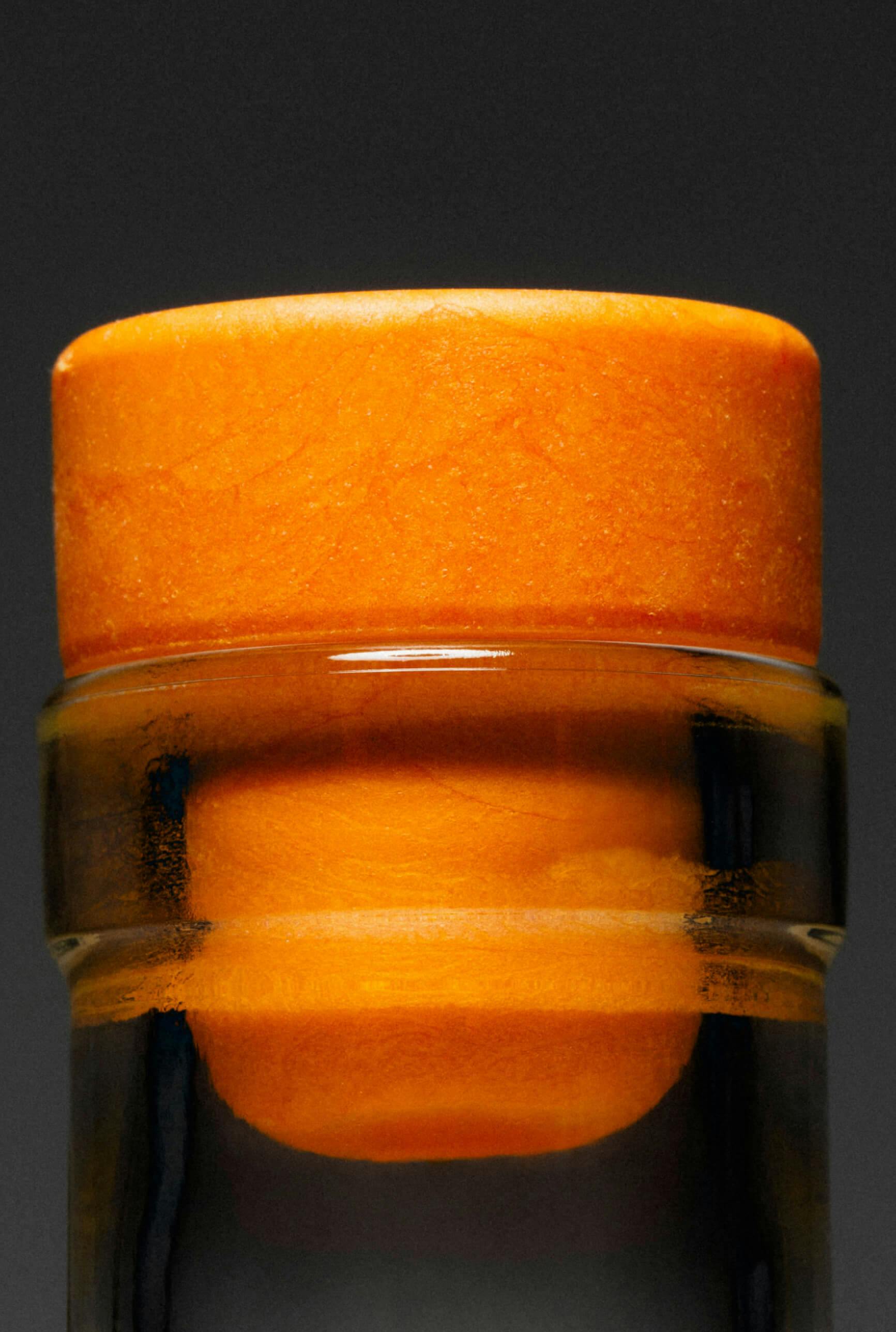 detail of orange rubber stopper in liquor bottle