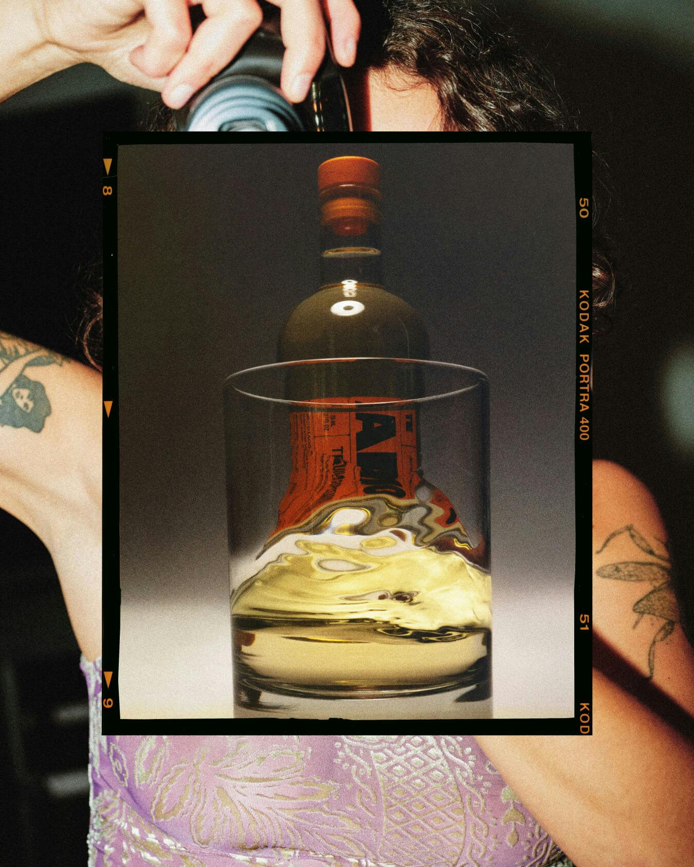 A photo collage showing a woman taking a picture and a photo of a liquor bottle