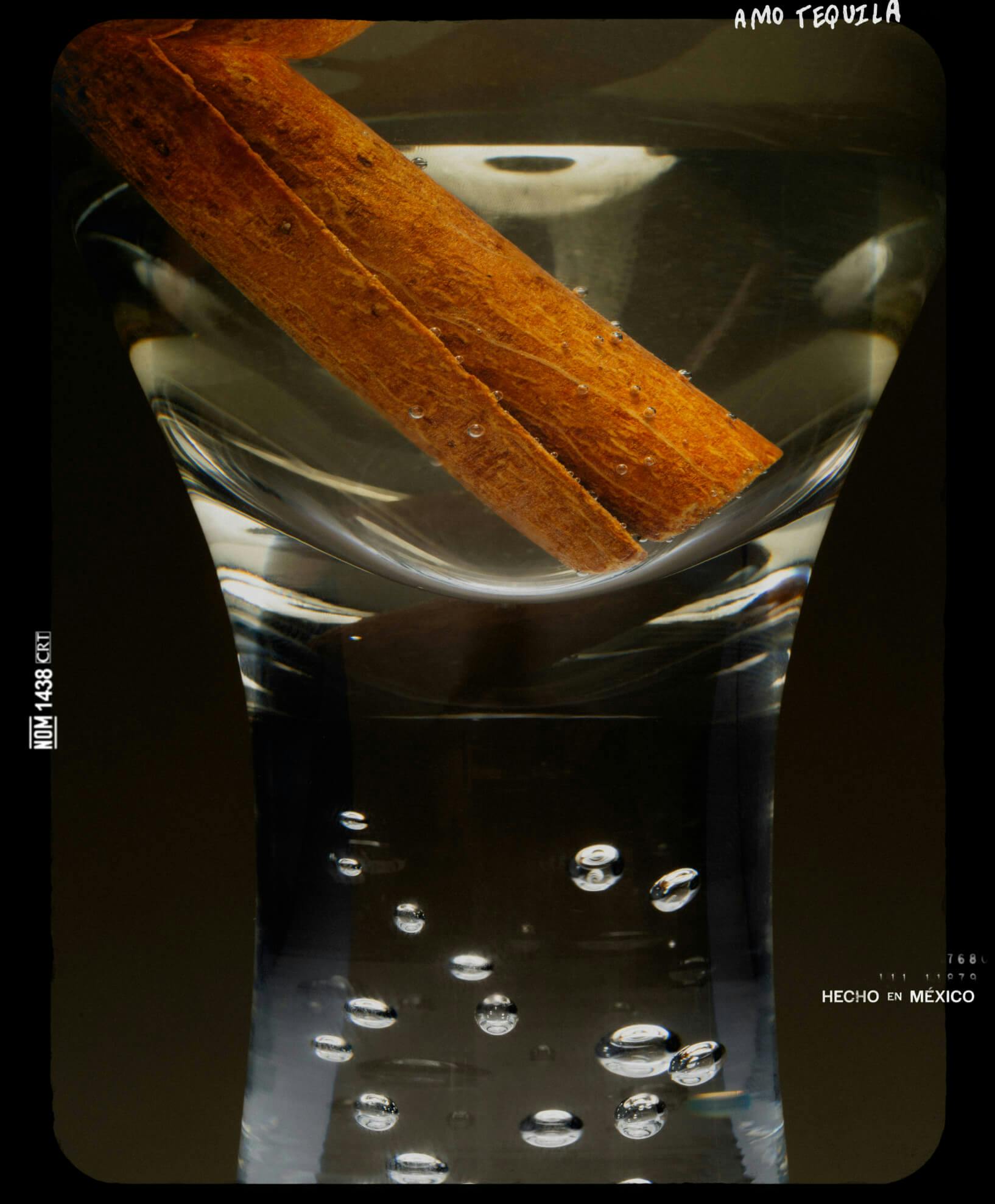 liquor in shot glass with cinnamon stick 