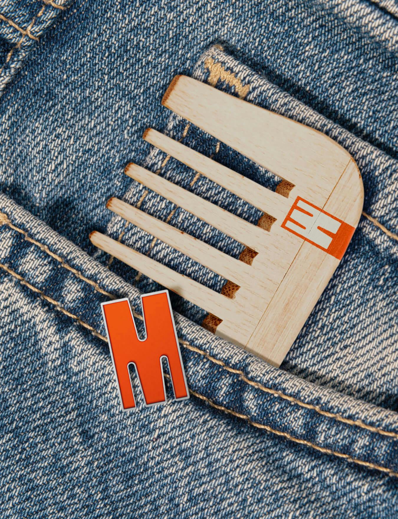 A wooden comb in a jeans pocket