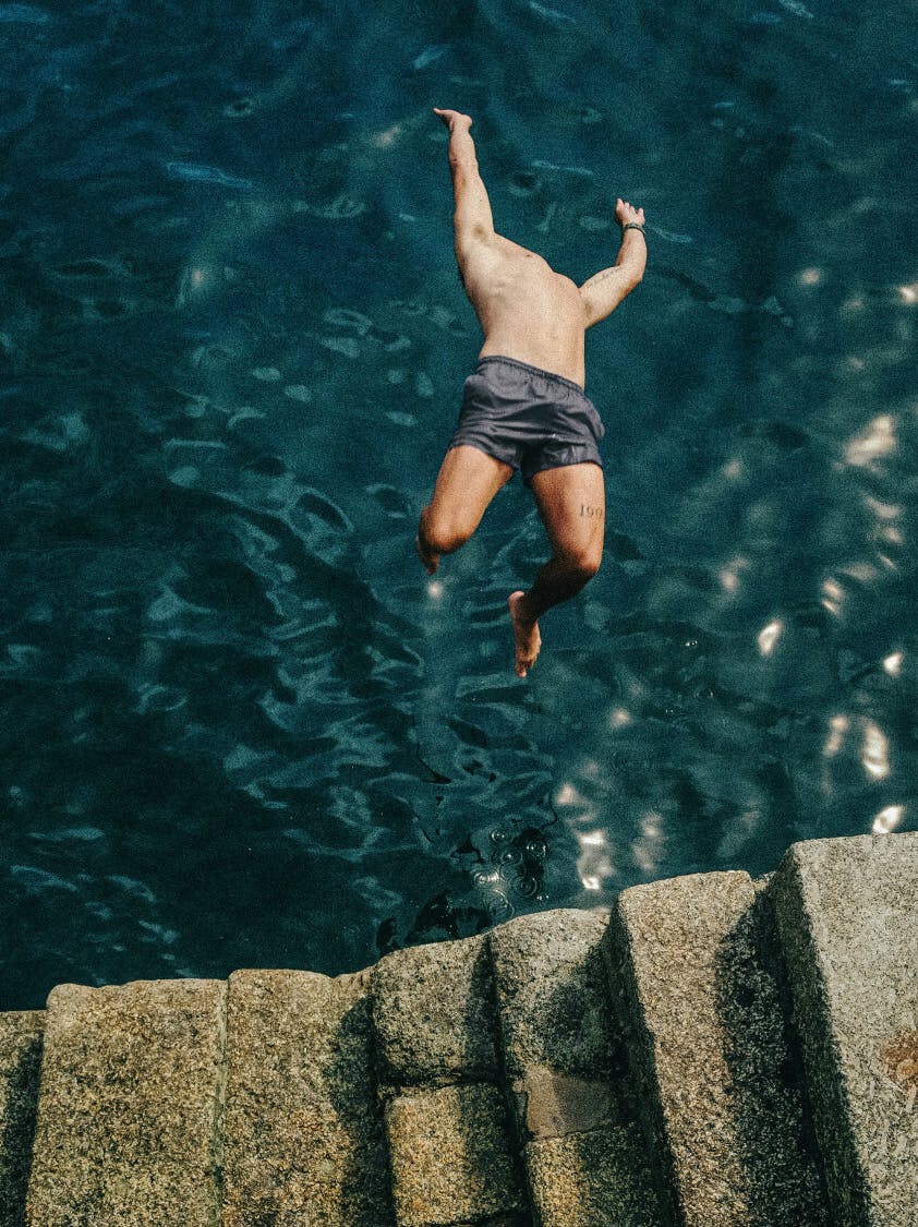 man diving into ocean