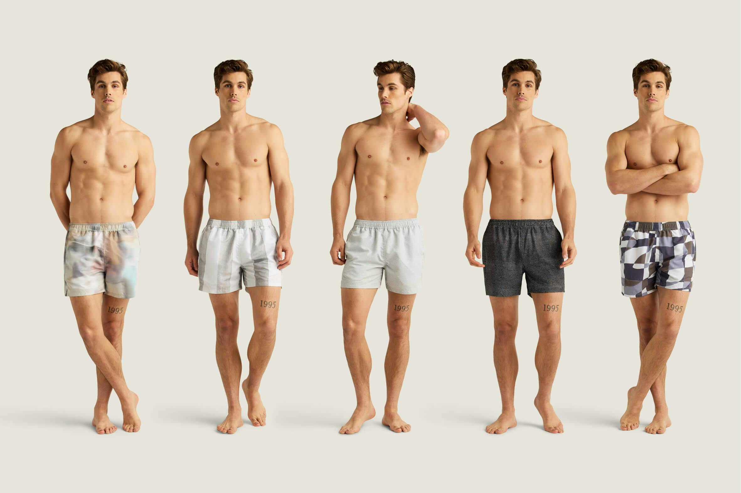 men modeling different colored swim trunks