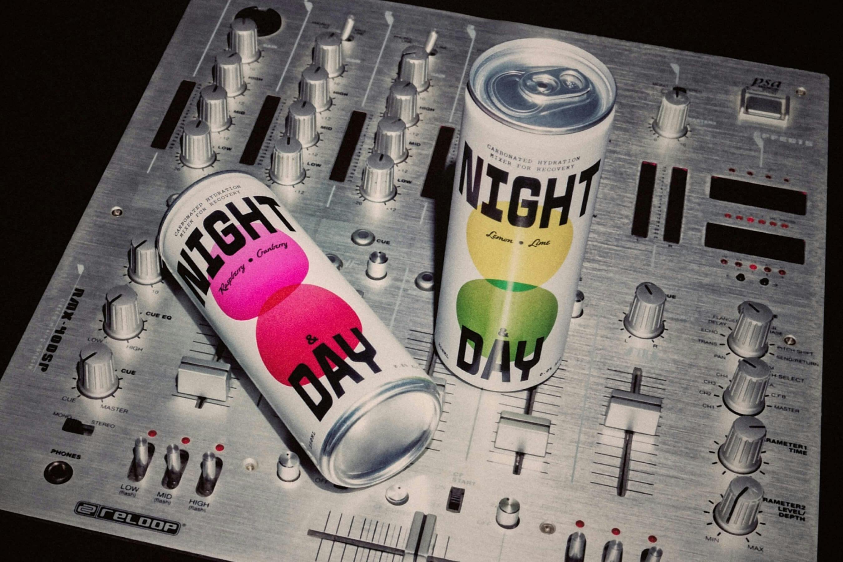 two canned beverages on top of DJ equipment