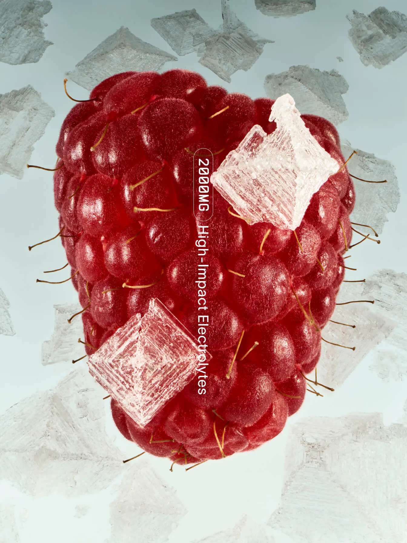 Surrealist macro image of an oversized raspberry studded with ice crystal cubes, with "2000MG High-Impact Electrolytes" overlaid vertically, against a pale blue background
