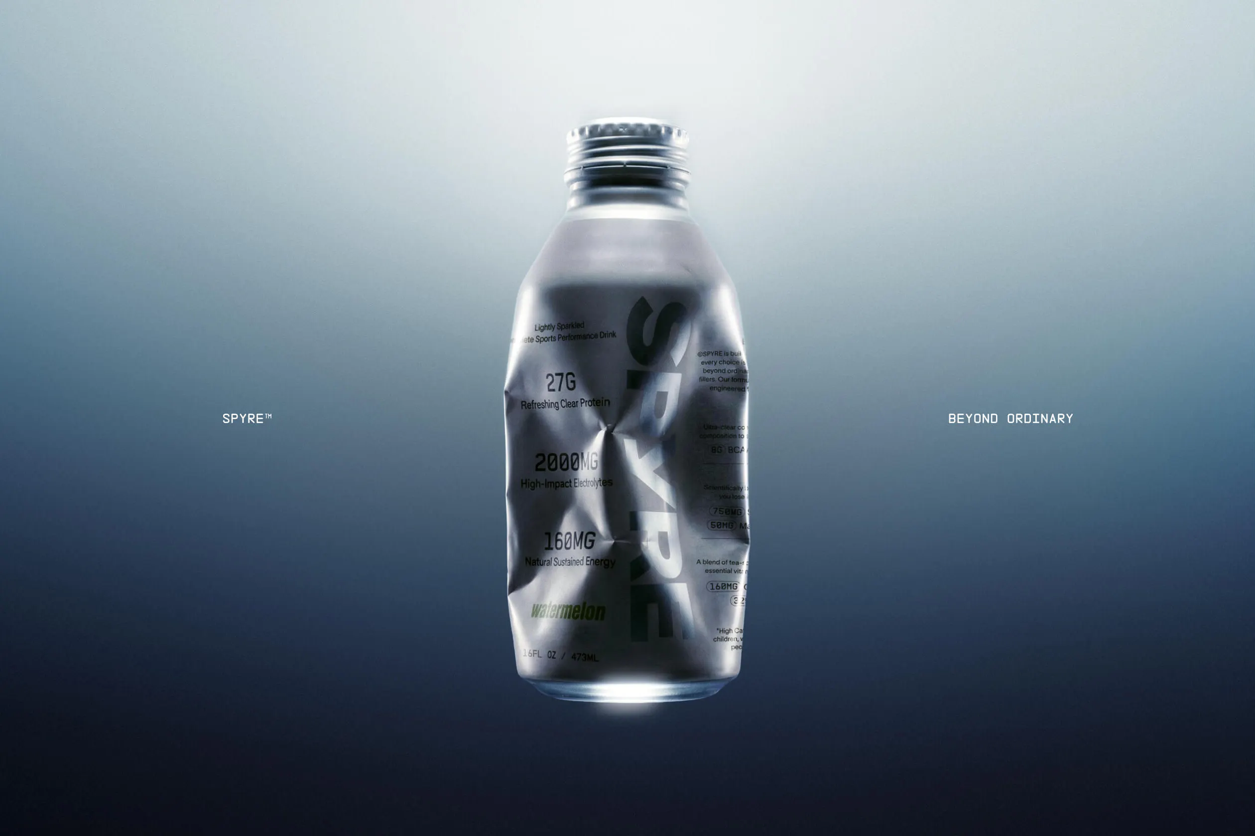 SPYRE watermelon bottle floating against a dark steel-blue gradient, crumpled and crushed, with "SPYRE™" and "BEYOND ORDINARY" type set at left and right margins