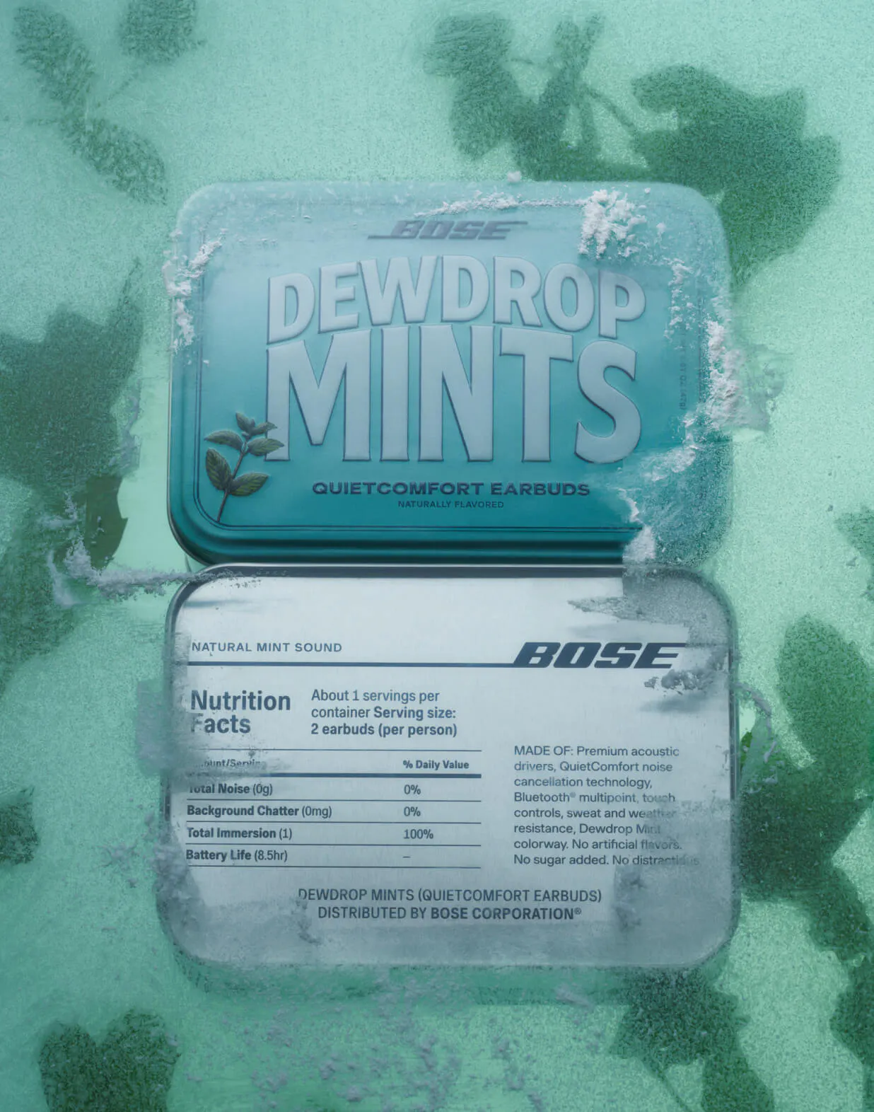 Front and back of the Bose Dewdrop Mints tin embedded in a sheet of ice with mint leaves frozen beneath the surface. The back panel displays a spoof nutrition label listing "Total Noise 0g," "Background Chatter 0mg," and "Total Immersion 100%."