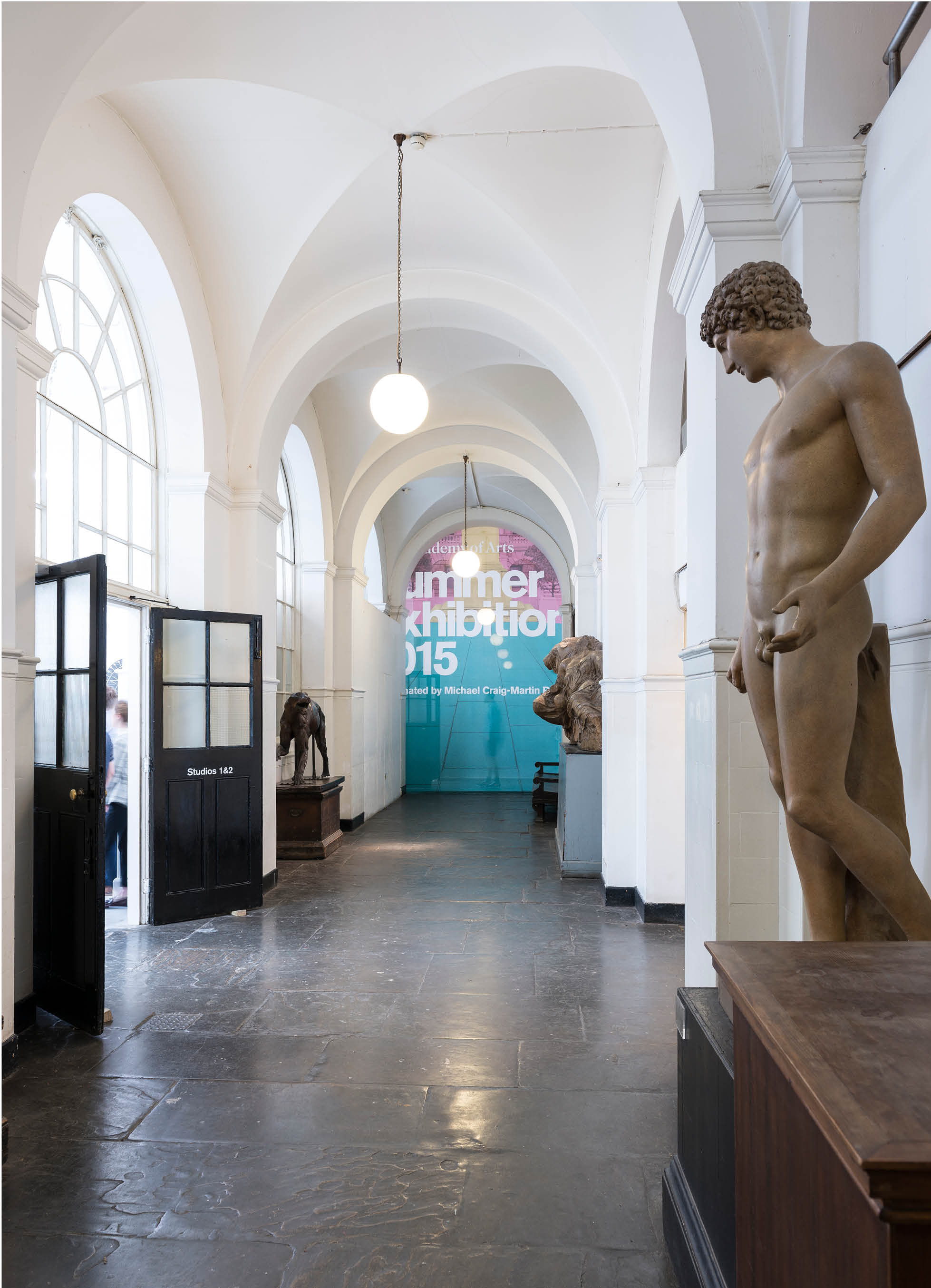 'The Greater Order', Sculptural installation by artist Henry Coleman across the Royal Academy buildings, London. Cast Corridor of the Royal Academy schools divided by a curtain made from the Banner for the Summer exhibition with members of the public shadowed behind