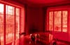 The effects', Sculptural installation by artist Henry Coleman. Dining room of JMW Turner's House, Sandycombe Lodge with red colored light coming through the garden windows, two reflective globes sit on an ornate table