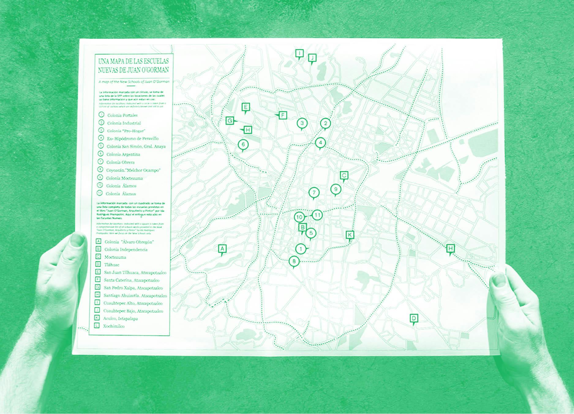 'Una Mapa Una Lista' by Henry Coleman produced for SOMA, Mexico City,  A green and white photograph of a pair of hands holding a map of the schools building program by the architect Juan O'Gorman