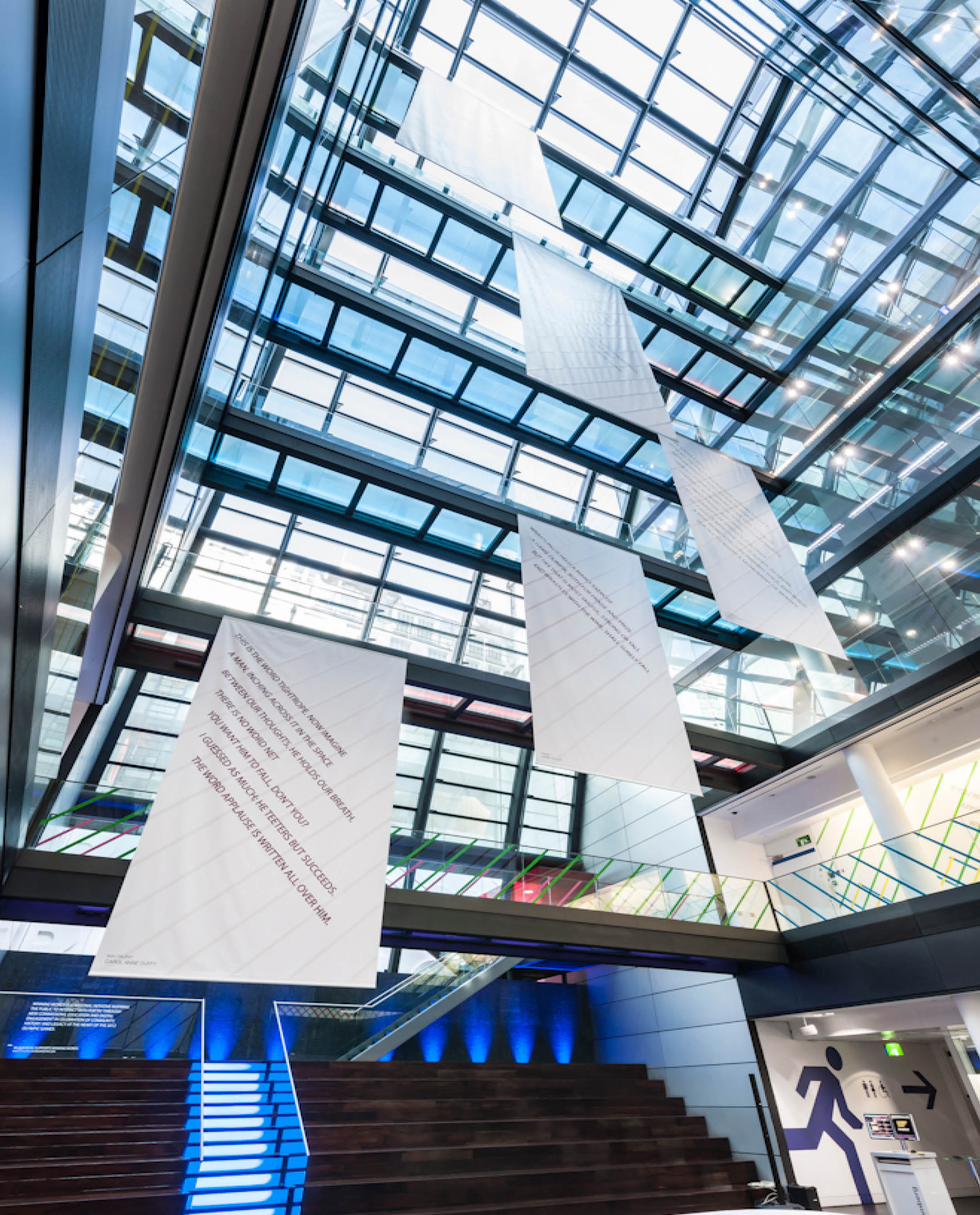 Winning words by Henry Coleman and Graham Reid, Olympic artwork project for the London 2012 Olympics, five large banners with poem text running diagonally across their surface hang suspended through the large glass atrium, 50 Finsbury square