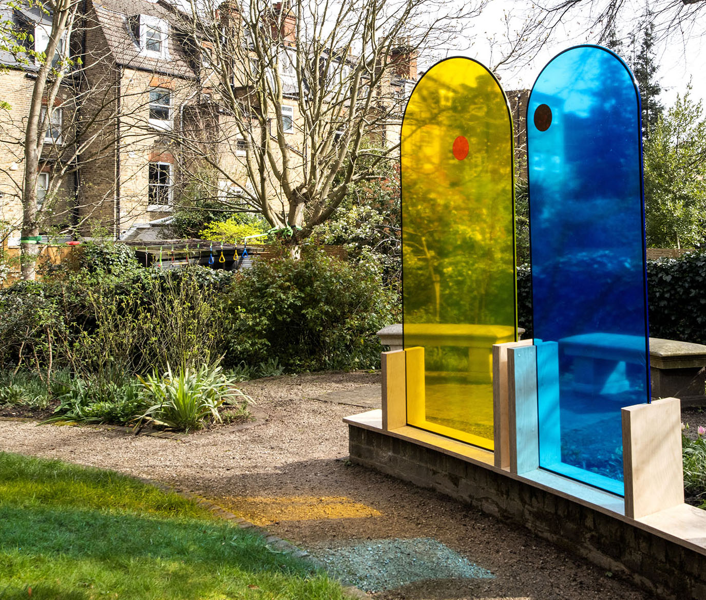 The union',  pair of colored glass arch shaped sculptures by the artist Henry Coleman placed in the garden of JMW Turner's House, Sandycombe Lodge, an artwork illuminating the friendship of JMW Turner and the architect Sir John Soane