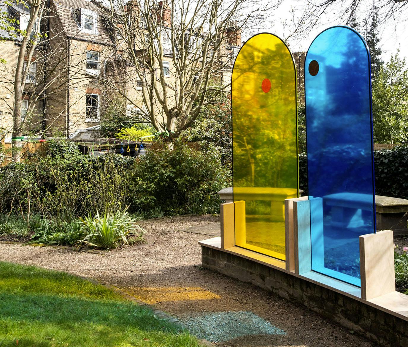 The union',  pair of colored glass arch shaped sculptures by the artist Henry Coleman placed in the garden of JMW Turner's House, Sandycombe Lodge, an artwork illuminating the friendship of JMW Turner and the architect Sir John Soane