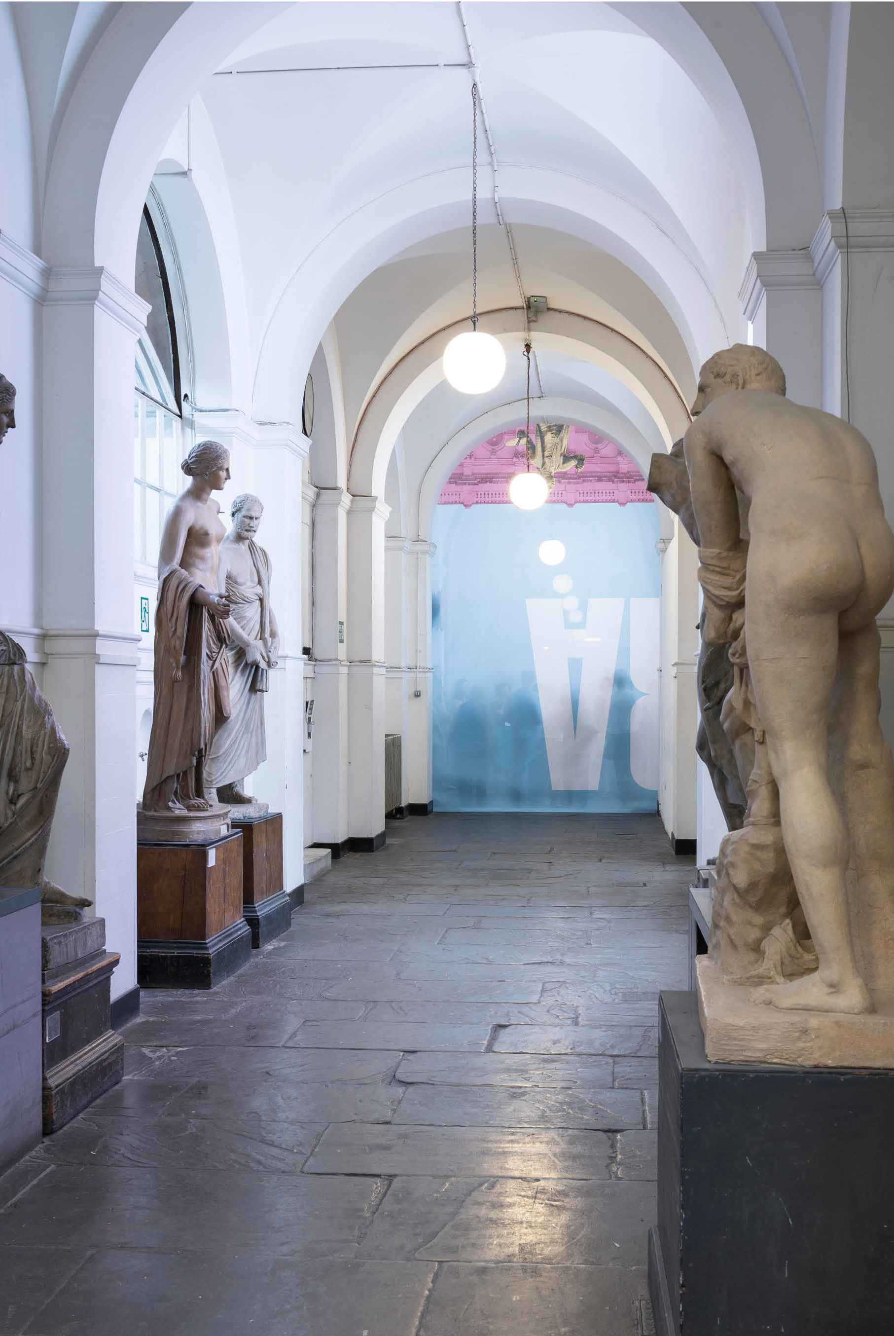 'The Greater Order', Sculptural installation by artist Henry Coleman across the Royal Academy buildings, London. Cast Corridor of the Royal Academy schools divided by a curtain made from the Banner for the Summer exhibition with members of the public shadowed behind