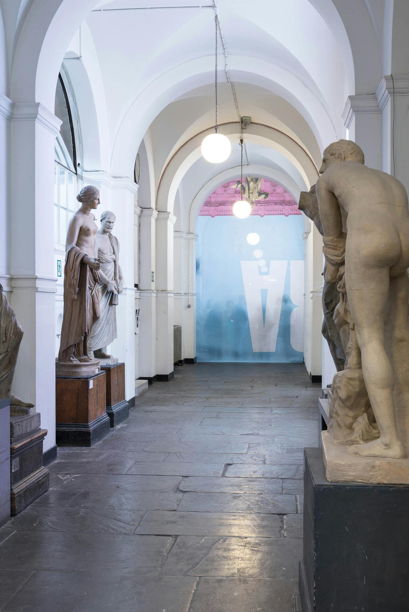 'The Greater Order', Sculptural installation by artist Henry Coleman across the Royal Academy buildings, London. Cast Corridor of the Royal Academy schools divided by a curtain made from the Banner for the Summer exhibition with members of the public shadowed behind