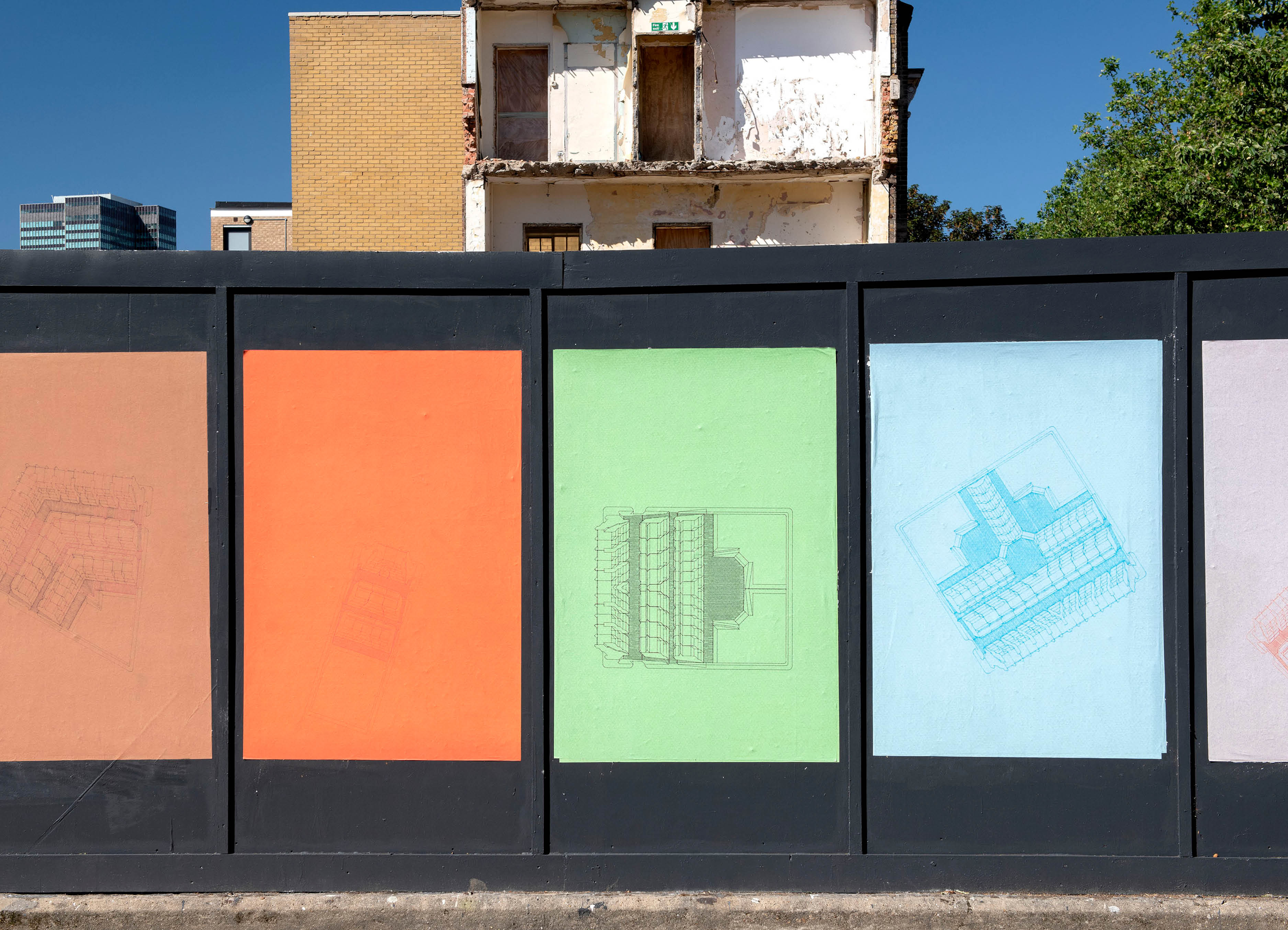 Life on other lines' by artist Henry Coleman. Installation of brightly colored posters based on drawings of the Polygon Estate, Somers Town by Architect Peter Tabori, pasted across a building hoarding against a bright blue sky