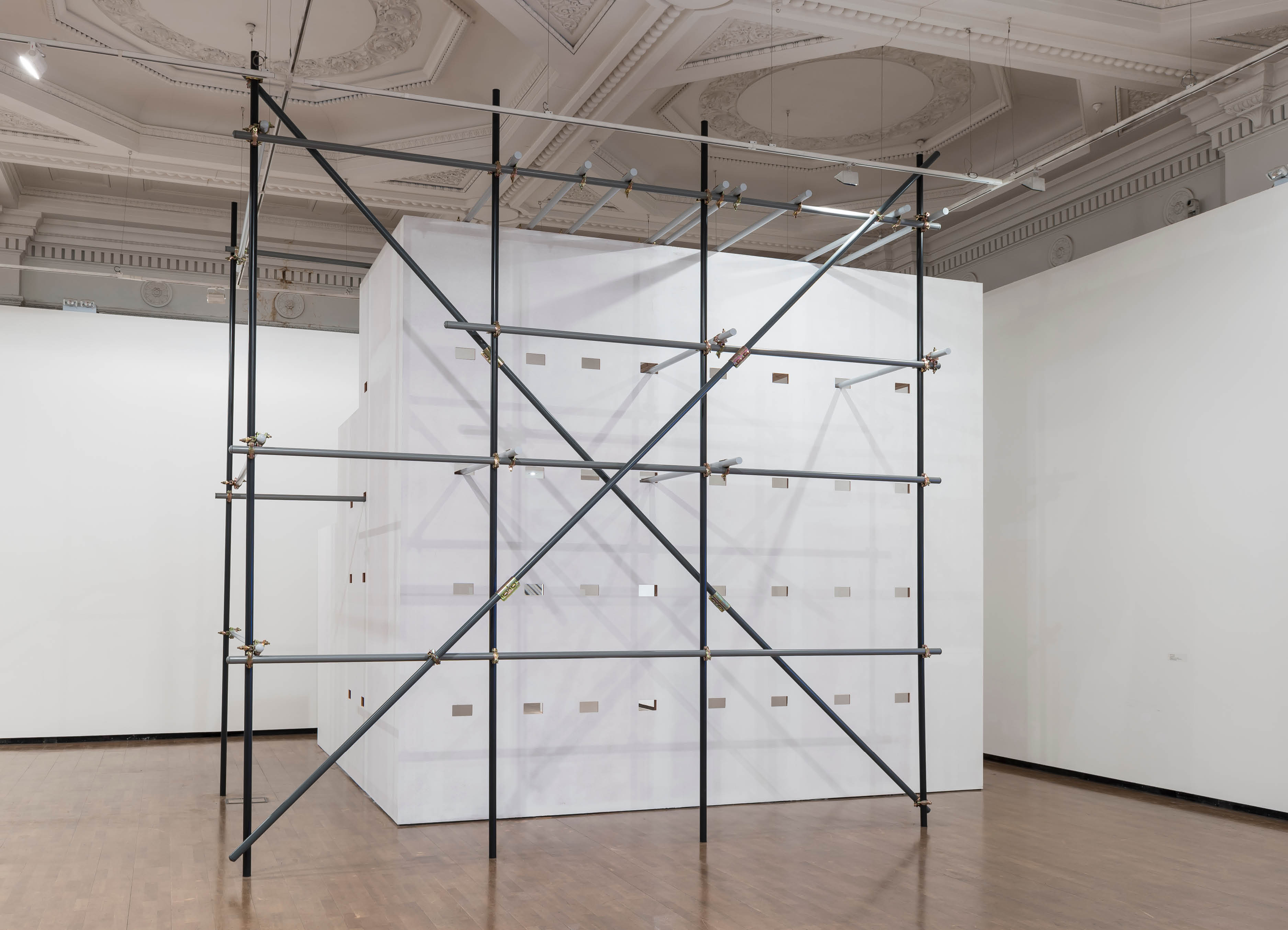 'Ornament, Work'  by Henry Coleman,  produced for the Royal Academy Premiums exhibition, a large temporary wall structure with decorative scaffolding in an ornate room at 6 Burlington gardens