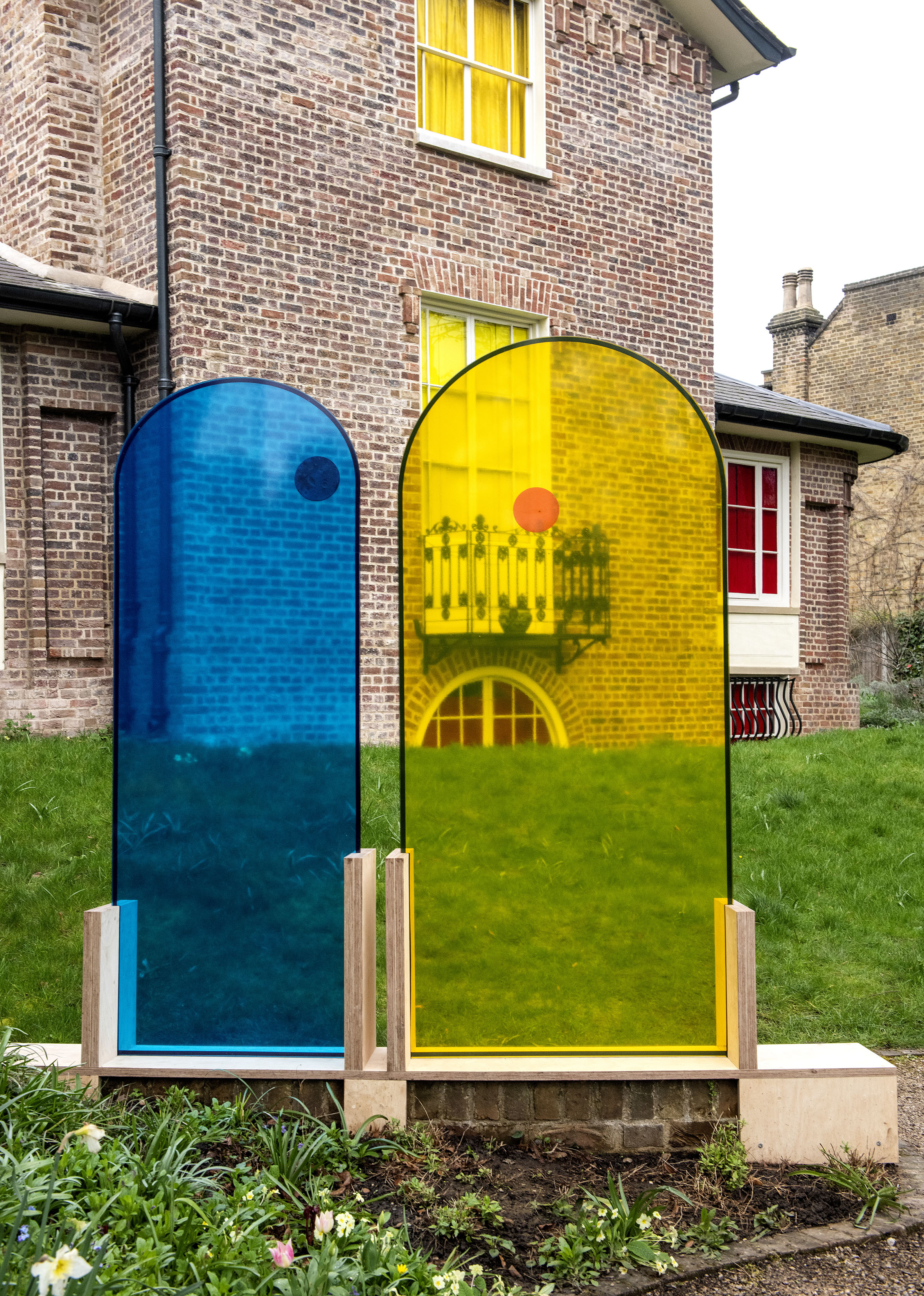 The union',  looking through a pair of colored glass arch shaped sculptures by the artist Henry Coleman to the rear of JMW Turner's House, Sandycombe Lodge, an artwork illuminating the friendship of JMW Turner and the architect Sir John Soane