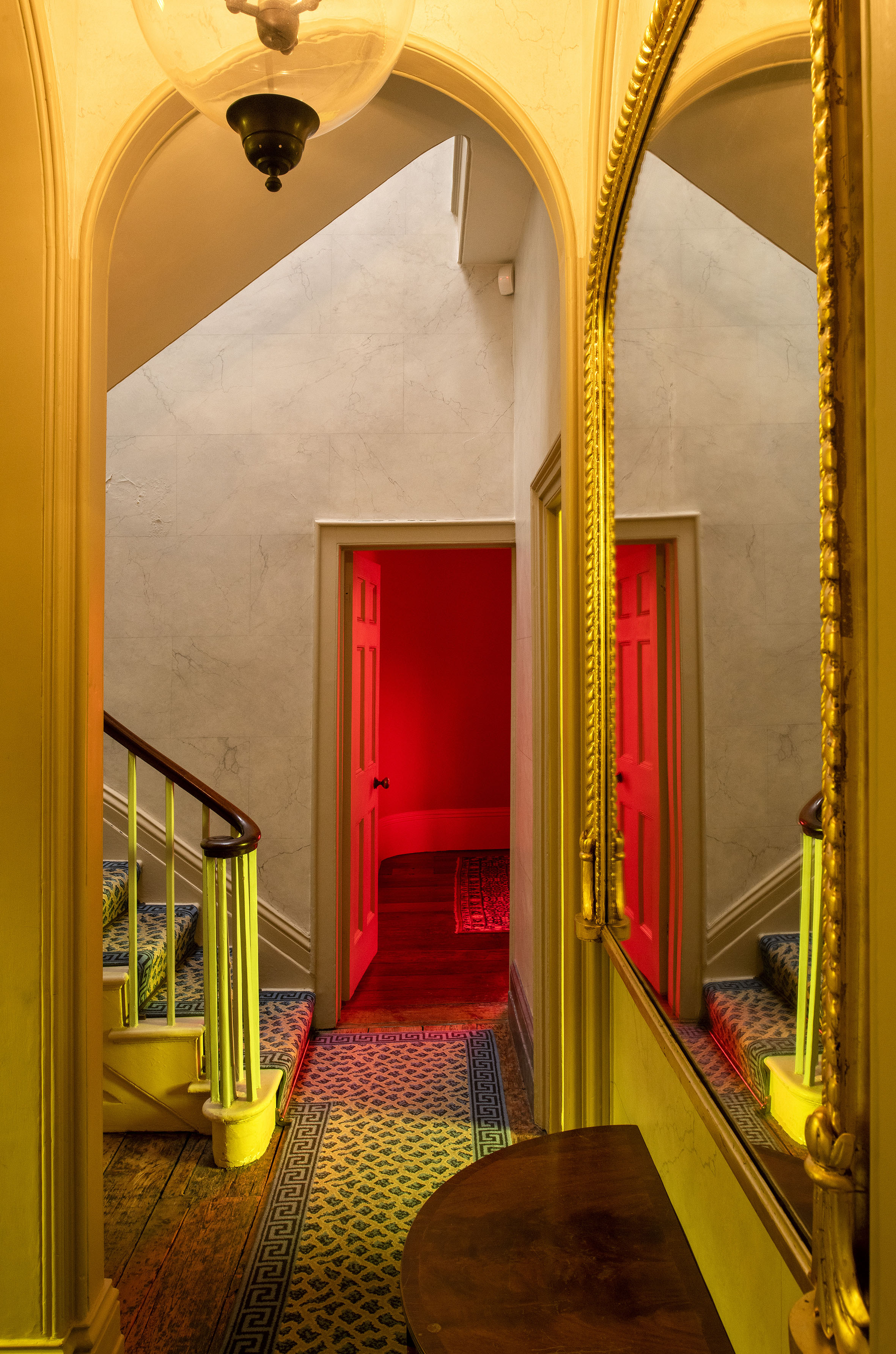 Colored light fills the hallway of JMW Turner's House, Sandycombe Lodge and is and is reflected in an ornate mirror in 'The effects', an architectural artwork in colored light by artist Henry Coleman  