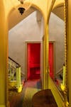 Colored light fills the hallway of JMW Turner's House, Sandycombe Lodge and is and is reflected in an ornate mirror in 'The effects', an architectural artwork in colored light by artist Henry Coleman  