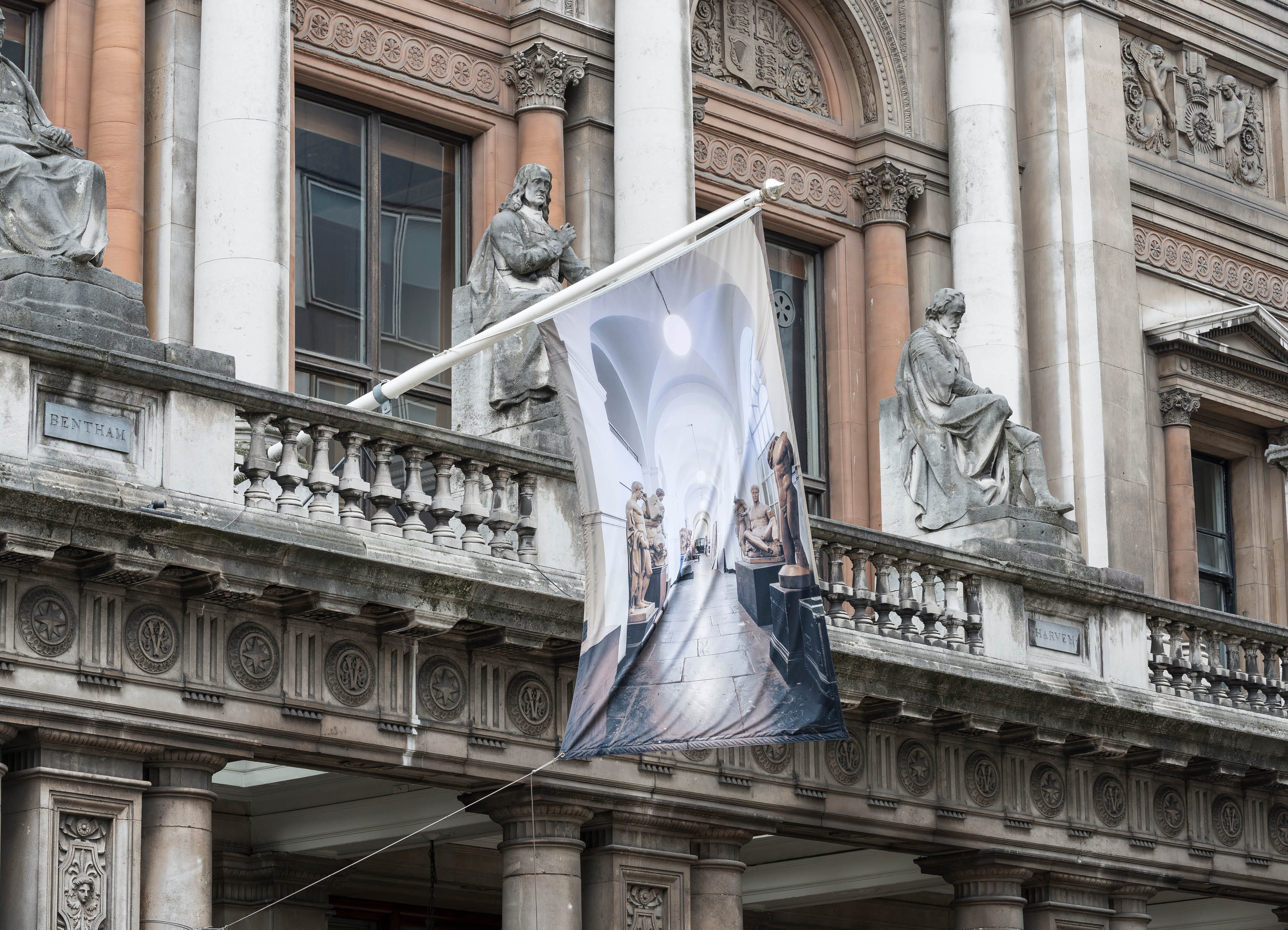 'The Greater Order', Sculptural installation by artist Henry Coleman across the Royal Academy buildings, London. Flag with an image of the Cast corridor, Royal Academy Schools,  flies in place of the RA flag on above the entry to 6 Burlington gardens