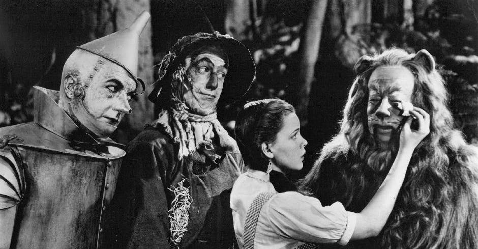 Production still from The Wizard of Oz. Judy Garland (as Dorothy) is touching up Bert Lahr's (as The Cowardly Lion) make-up