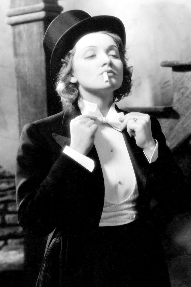 Portrait of Marlene Dietrich adjusting her bow-tie