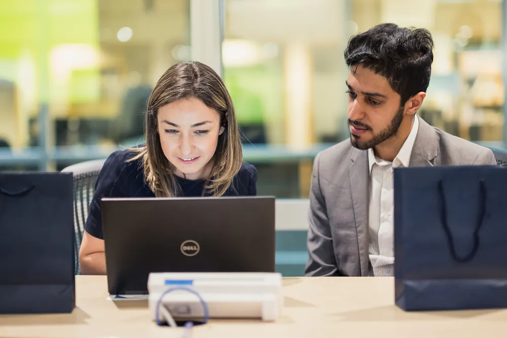 Two people at laptops
