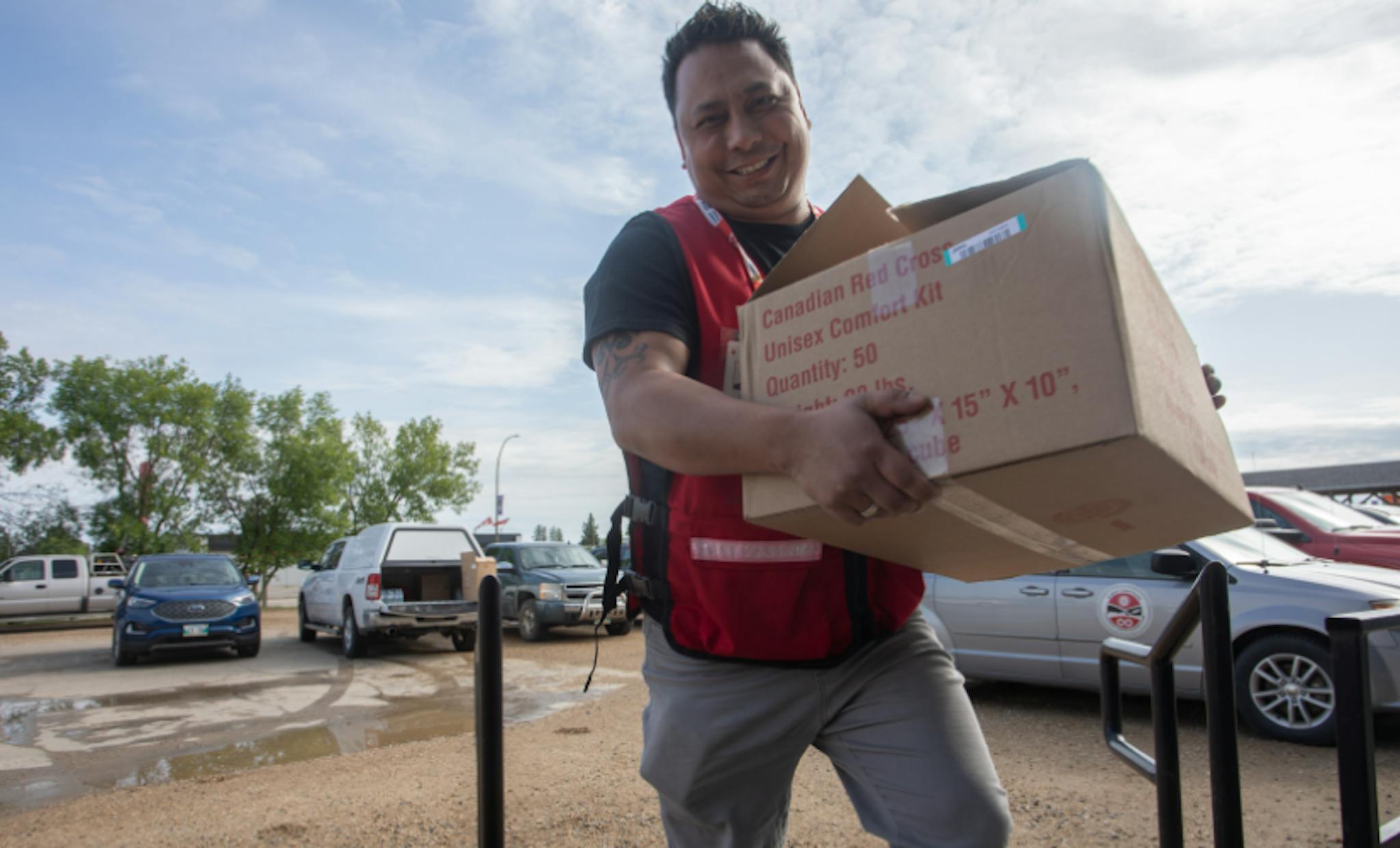 Canadian Red Cross volunteer handling supplies.
