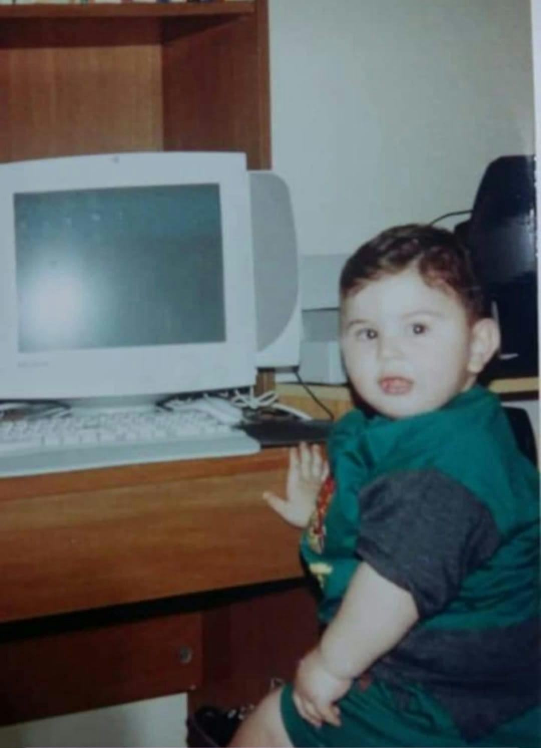 Toddler Hicham ElMir Sitting in front of his father's computer