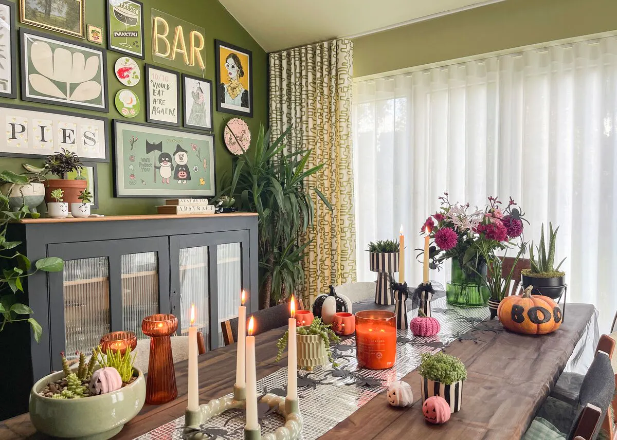 Dining room window dressed with sheer white curtains, softly filtering daylight beside patterned drapes and an autumn-styled table setting.