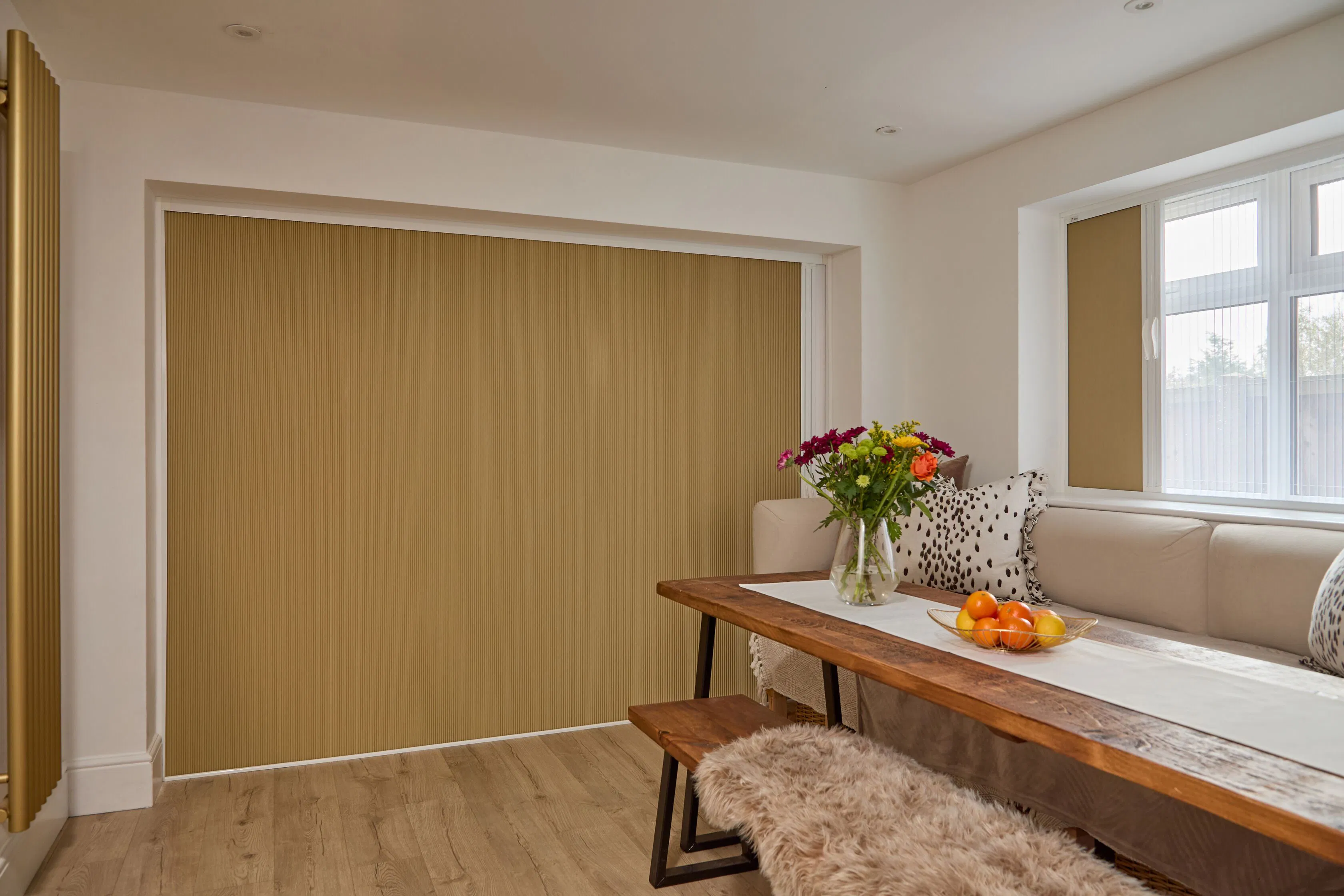 Large Blind Screen covering wide patio doors, with a matching blind at the window beside a dining table and wooden bench.