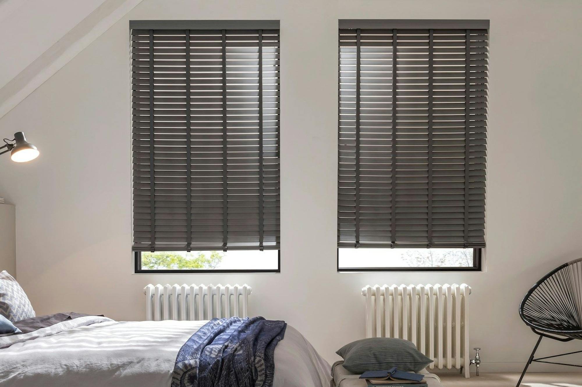 Large bedroom with contrasting dark wooden blinds