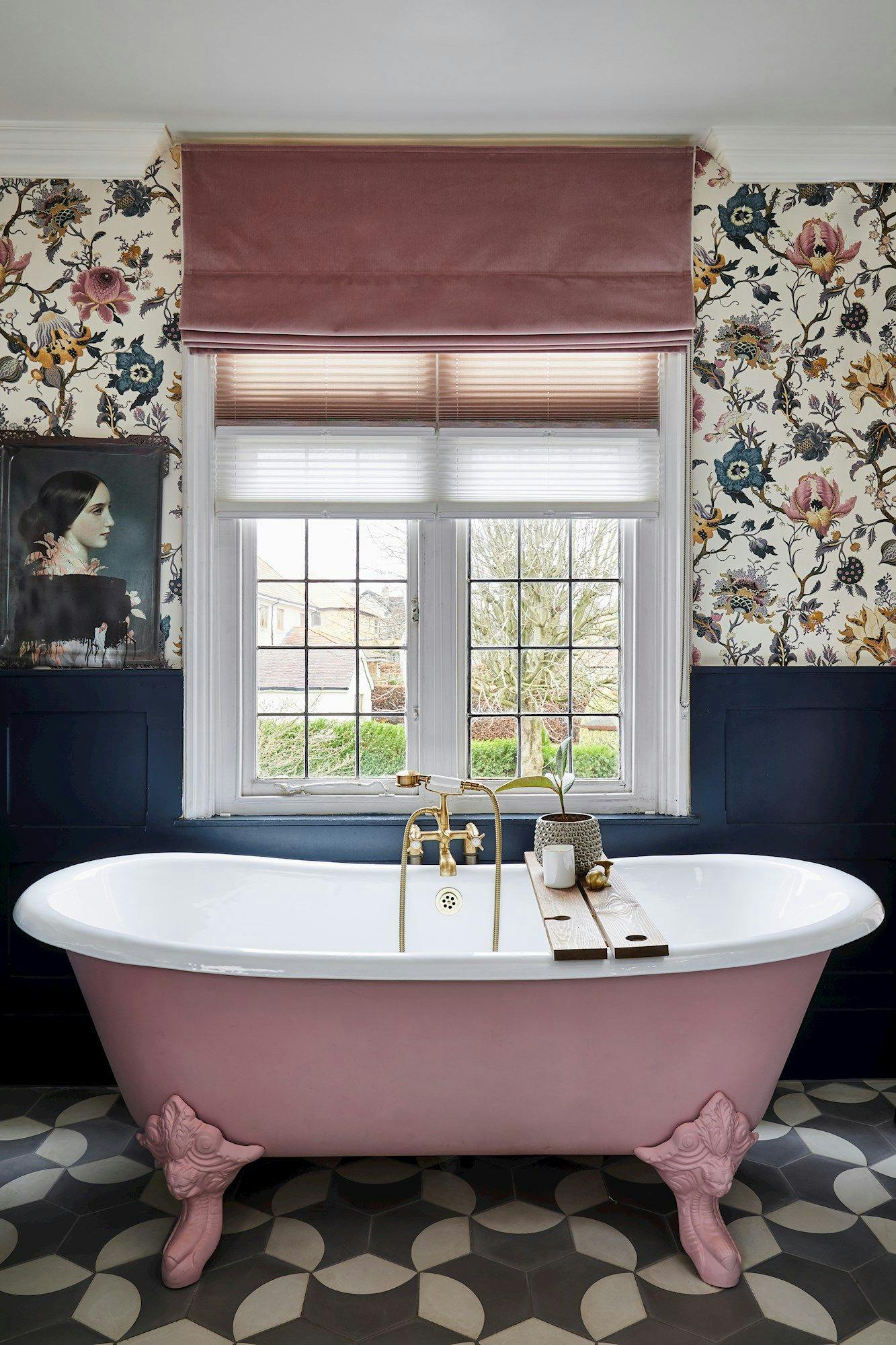 Rose pink, velvet roman blind over light, pleated blinds in a floral bathroom with rose pink and navy accents