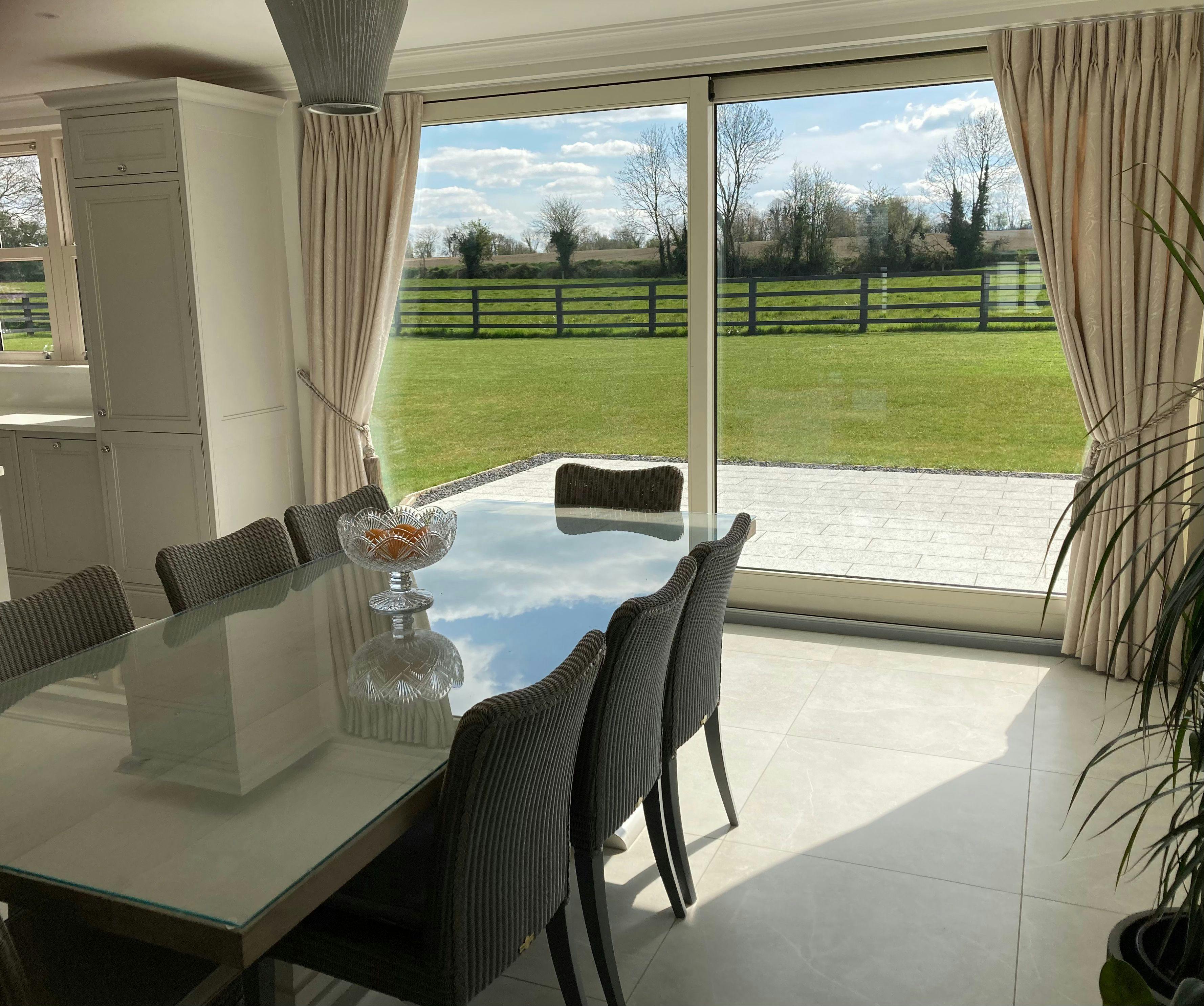 Cream pinch pleat curtains in a modern dining room
