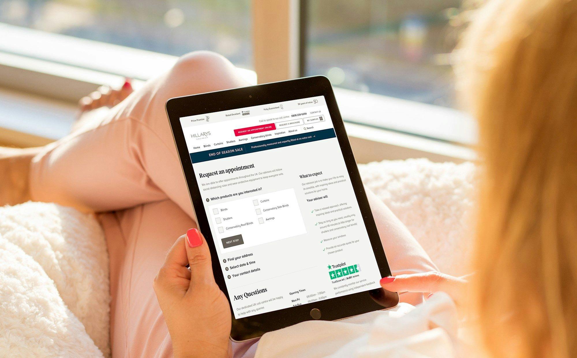 someone booking an appointment on the Hillarys website using a tablet device