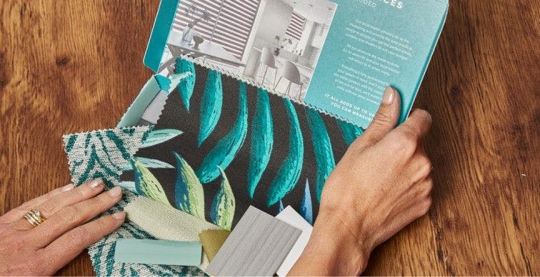 Female hands feeling quality Hillarys fabric samples in the sample pack