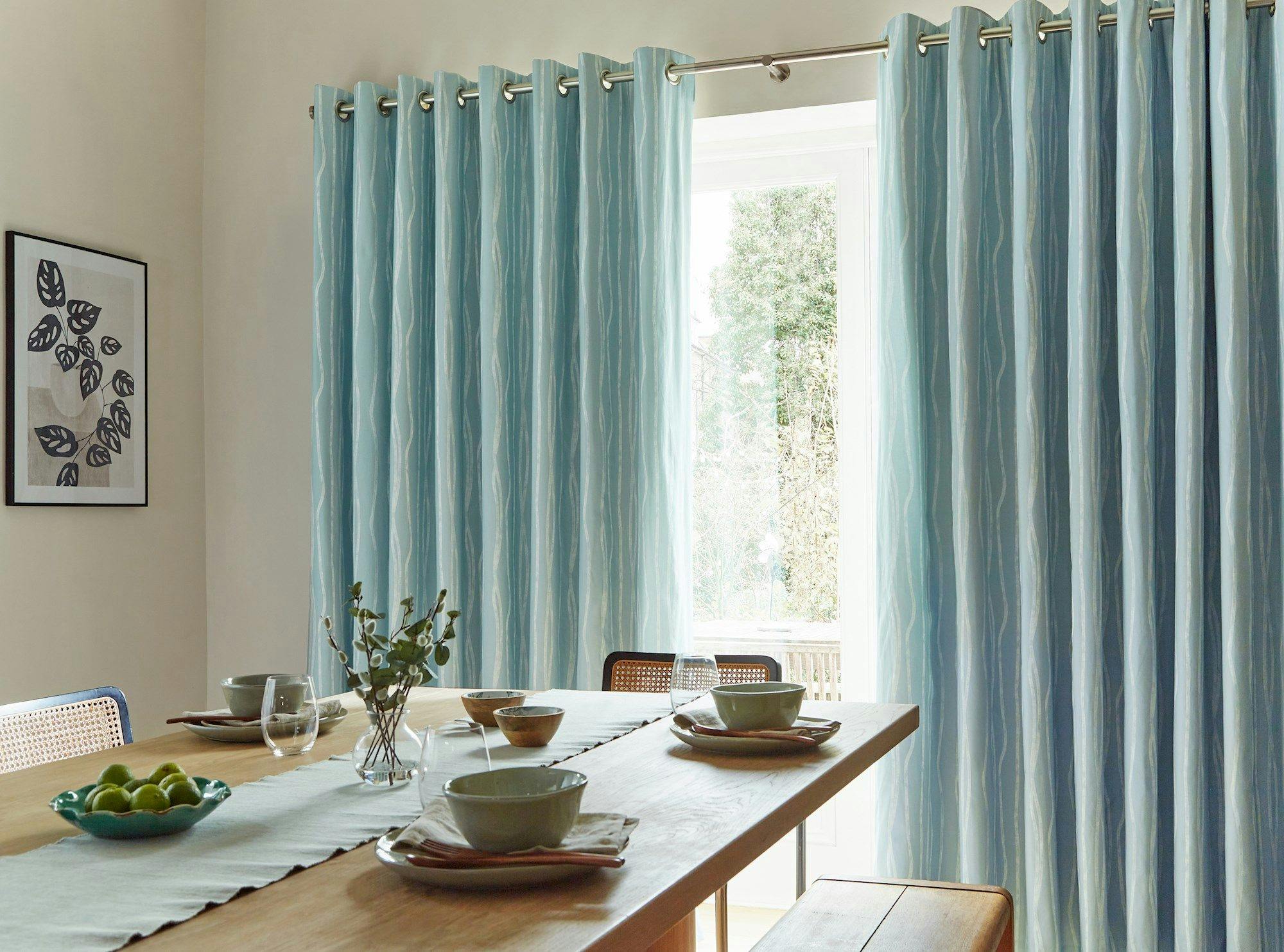 Flow Glacier curtains opened in a dining room window