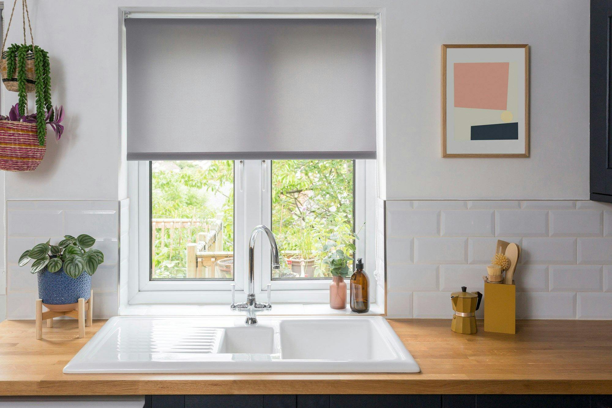 reber ash roller blind in kitchen window above white sink