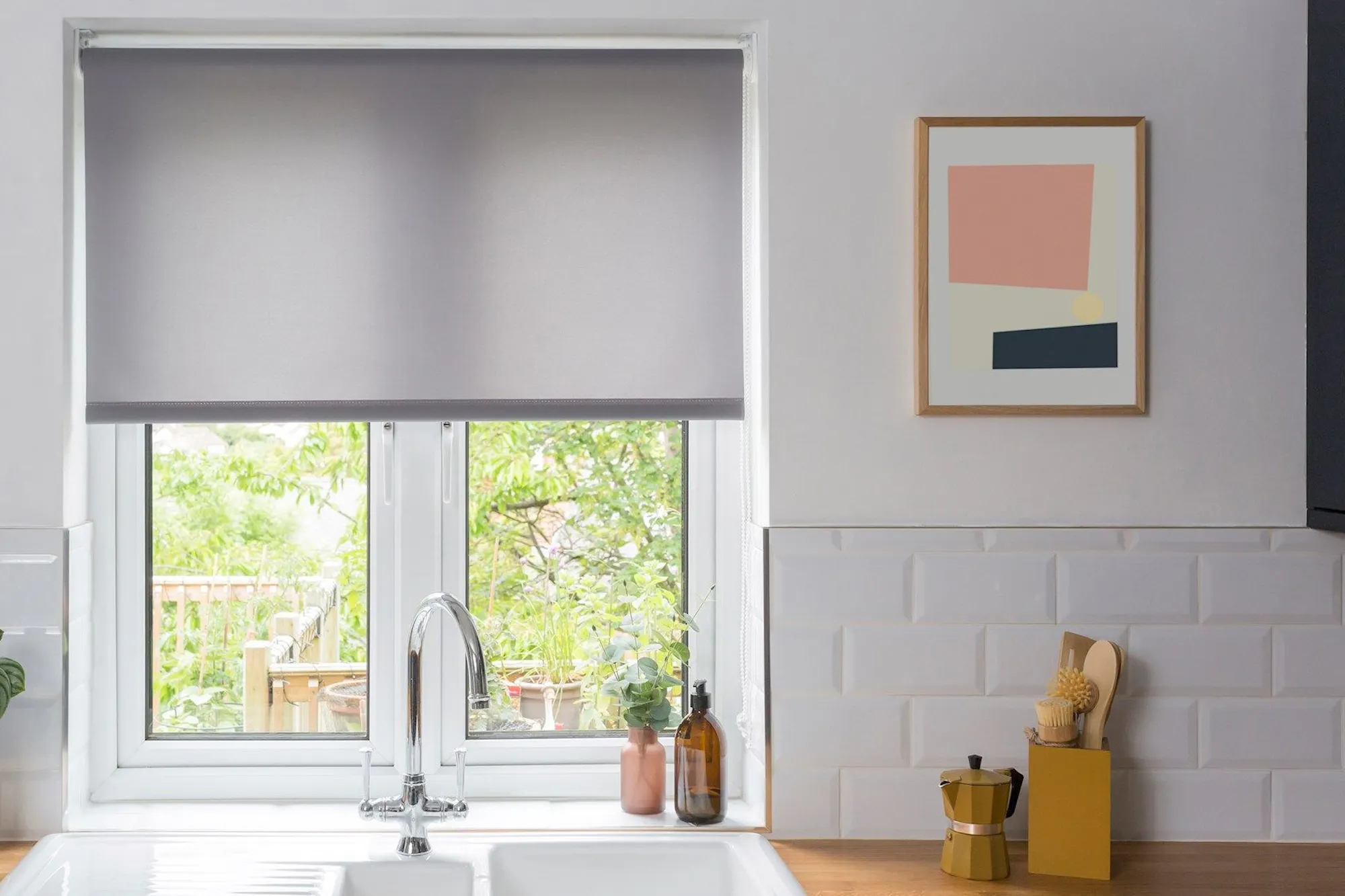 reber ash roller blind in kitchen window above white sink