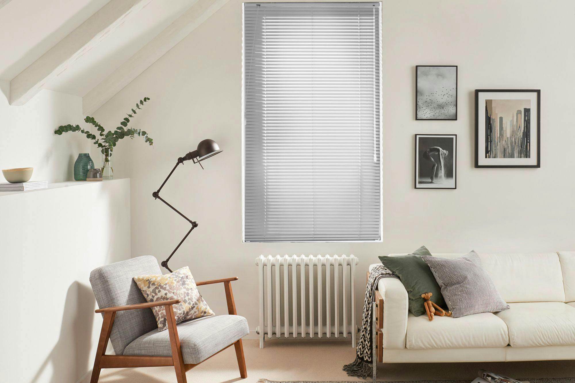 Grey metal venetian blind in cream bedroom